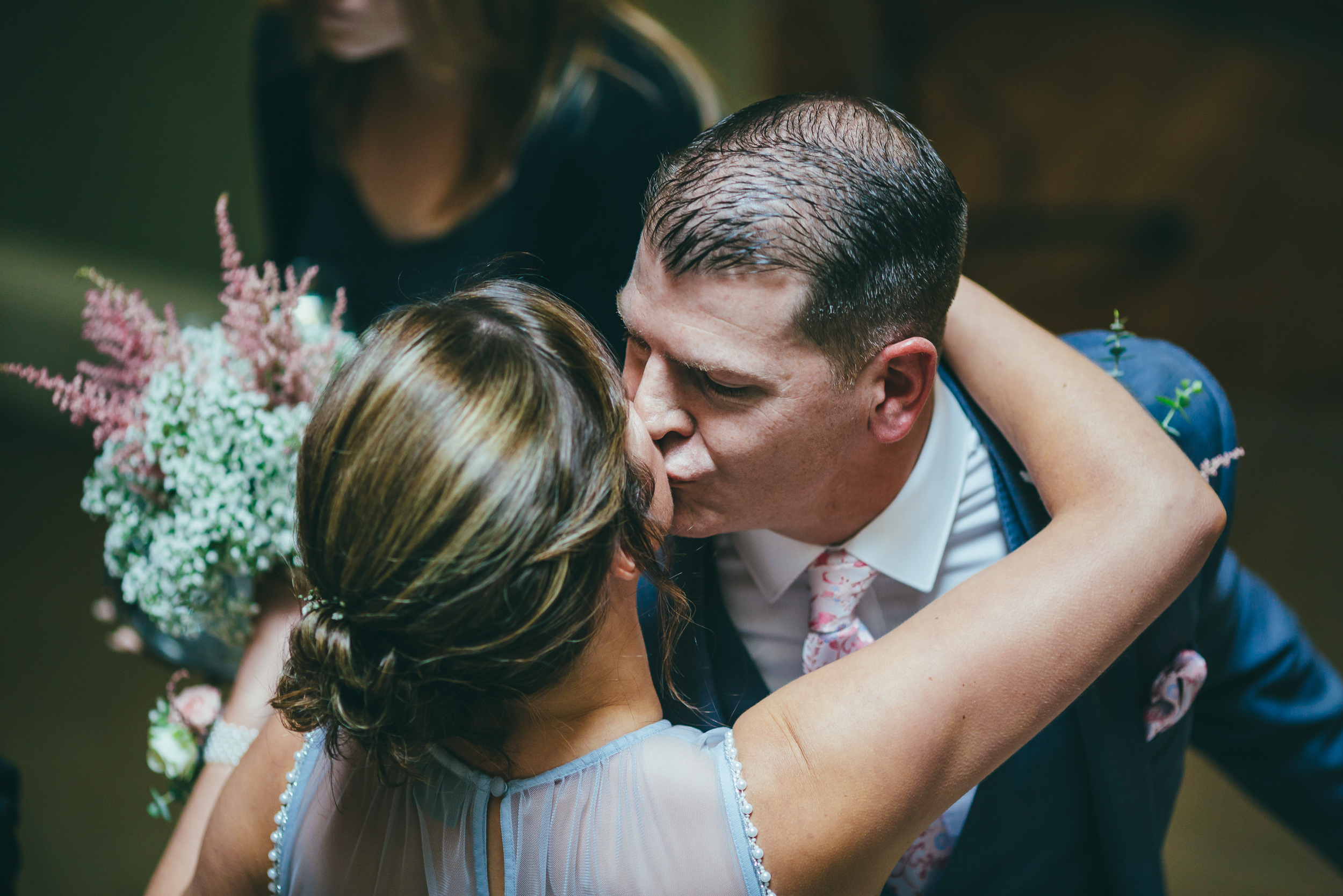 Groom kissing