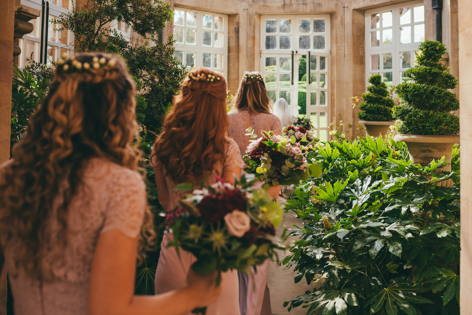 bridesmaids walking through the conservatory