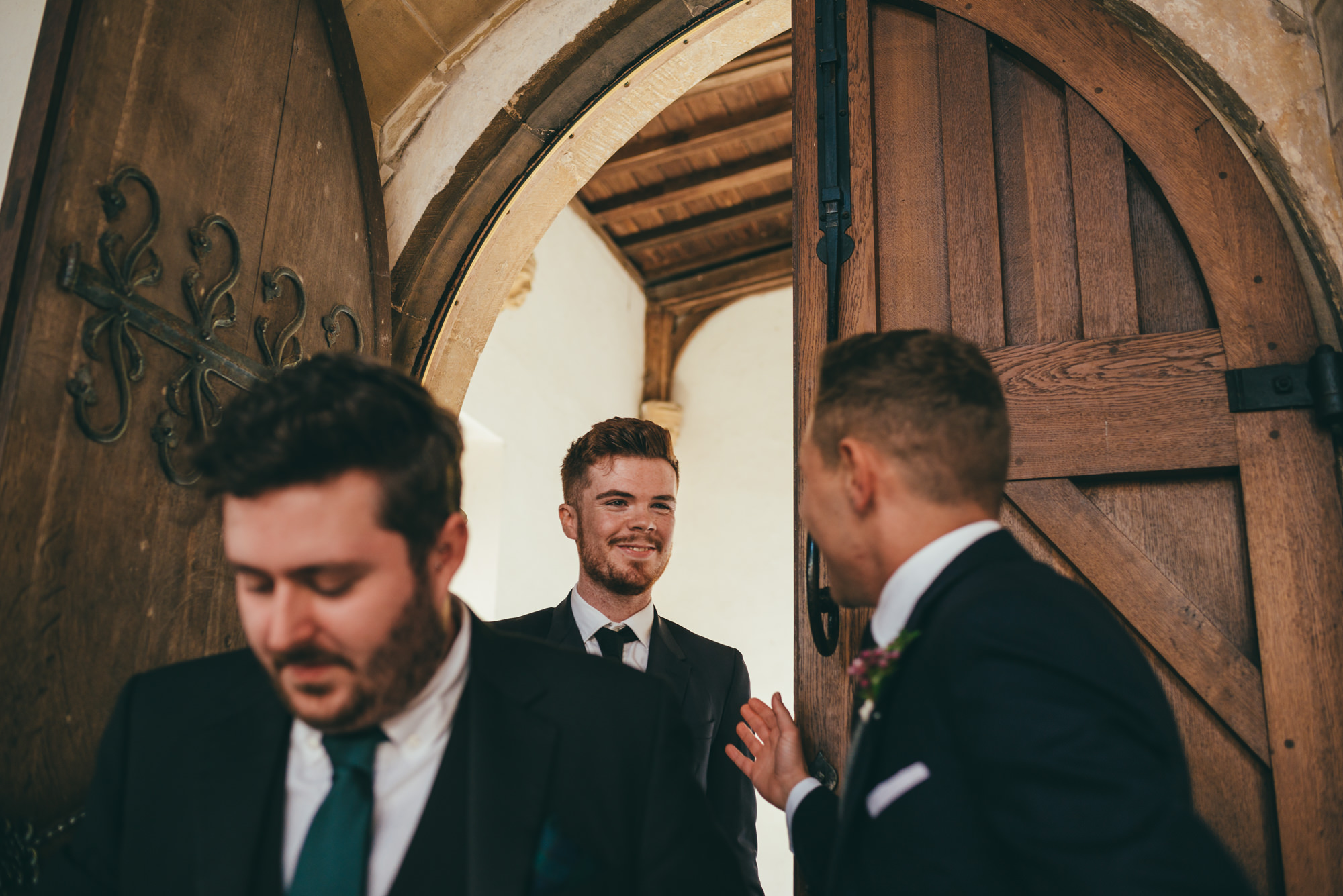 Groom greeting wedding guests