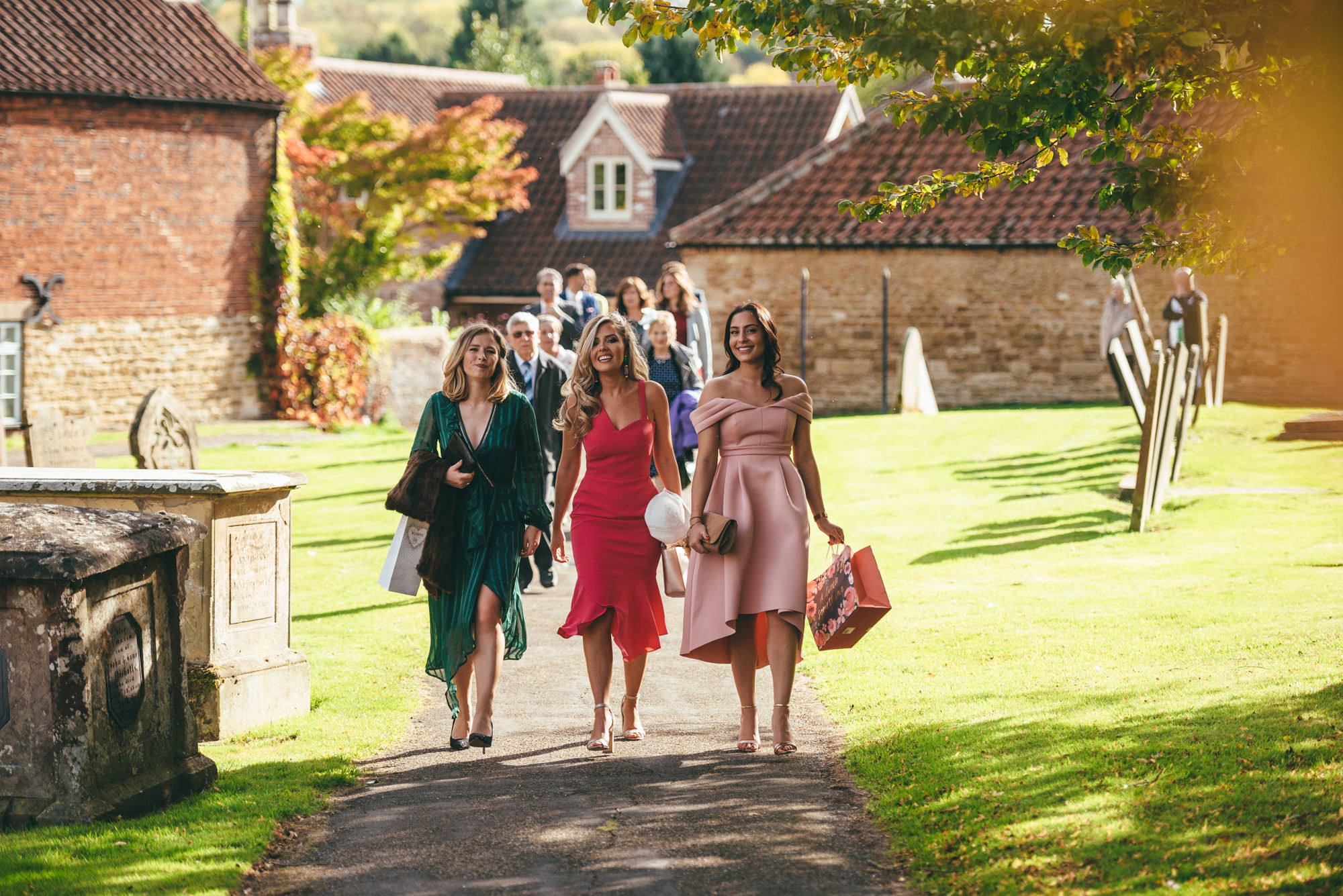 female wedding guests arrive at church