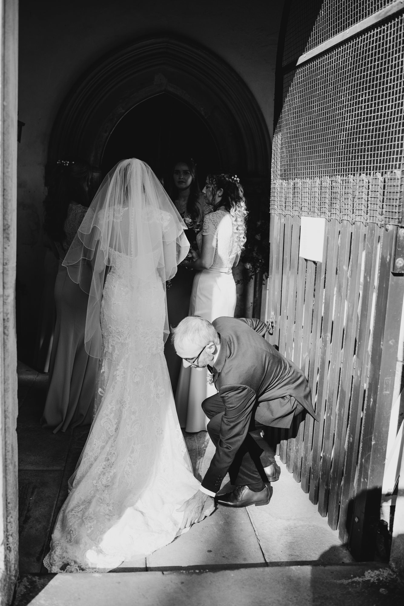 father fixing brides dress