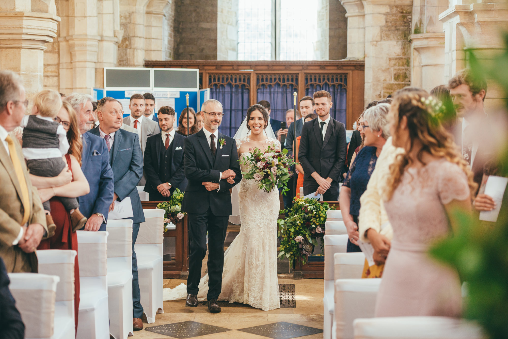 bride walks down the aisle with her father