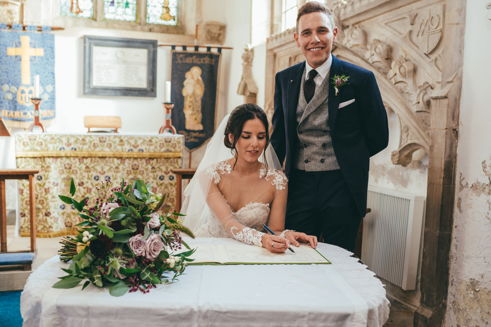 photograph of the bride and groom signing the wedding register