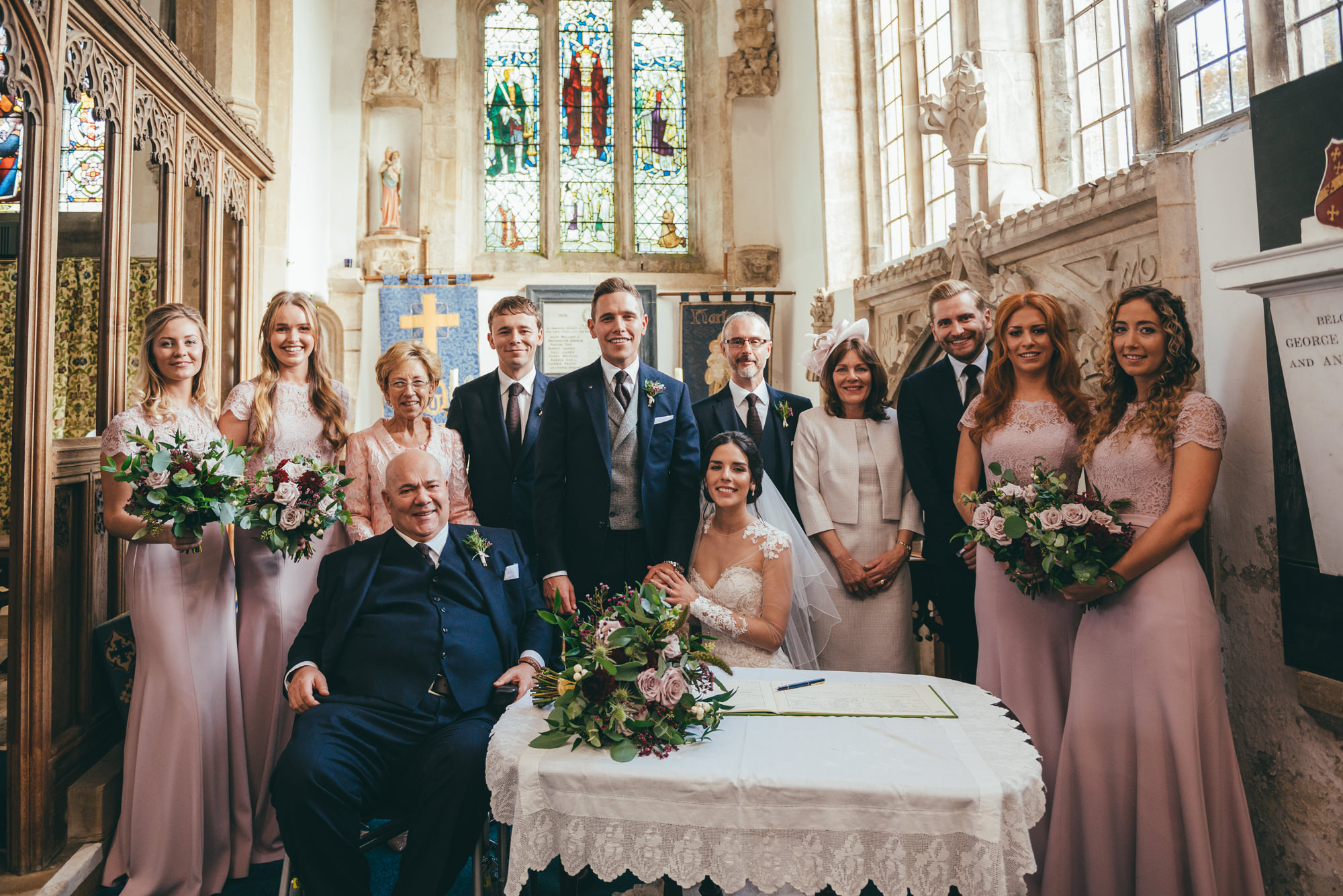 posed photograph of the bridal party at harlaxton church