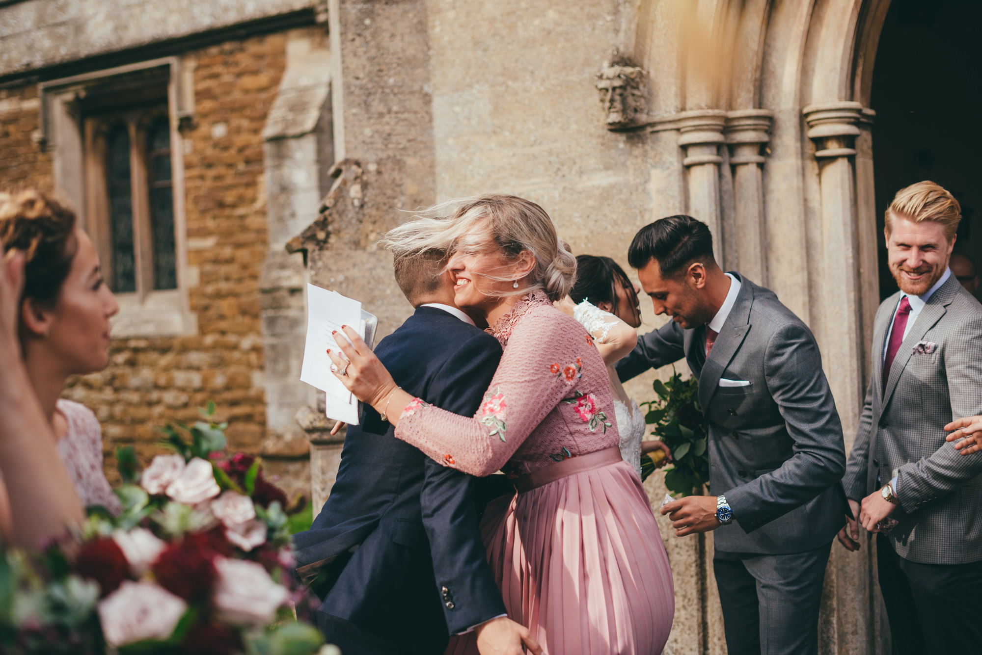 guests hugging after the wedding ceremony