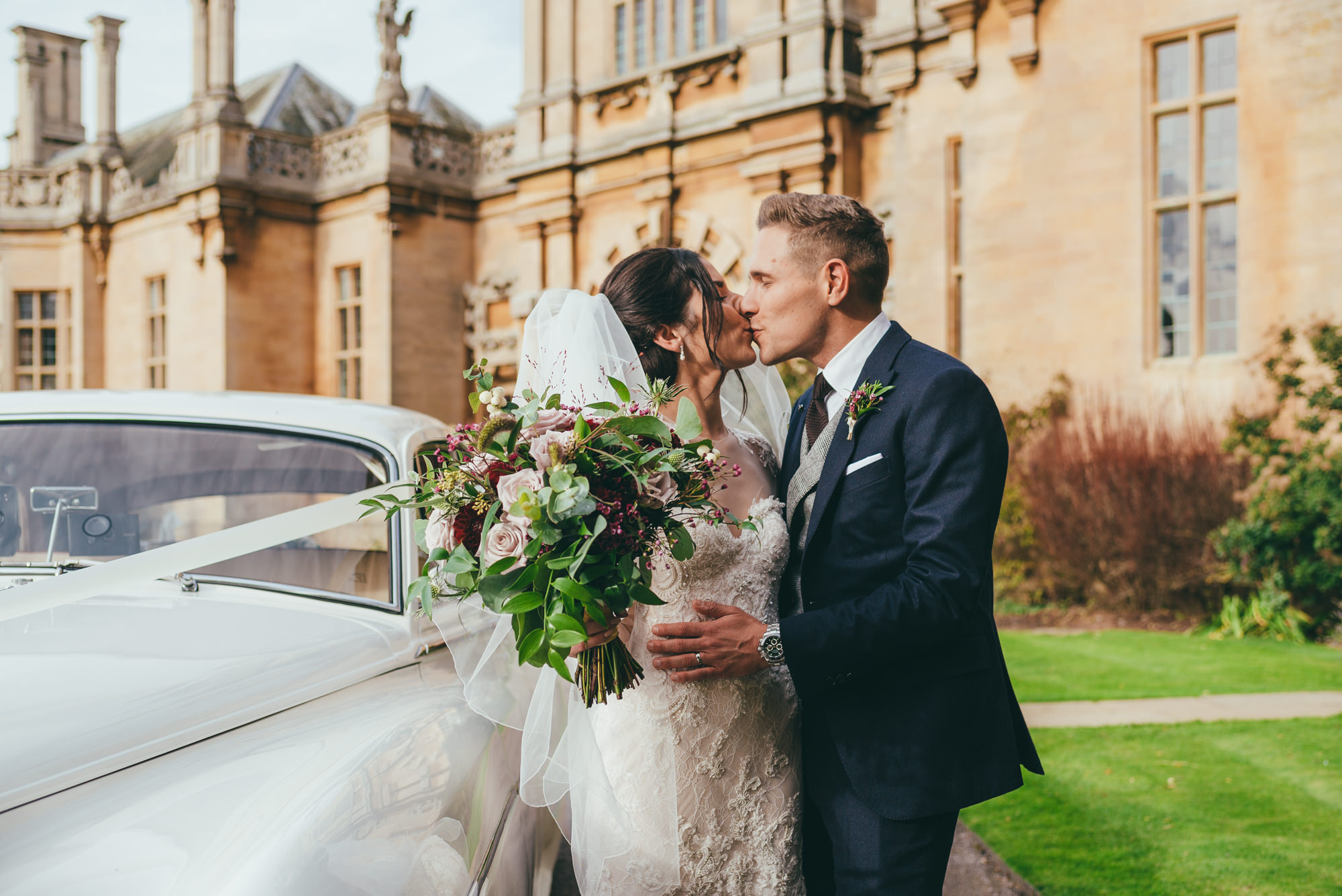 bride and groom kissing at harlaxton manor