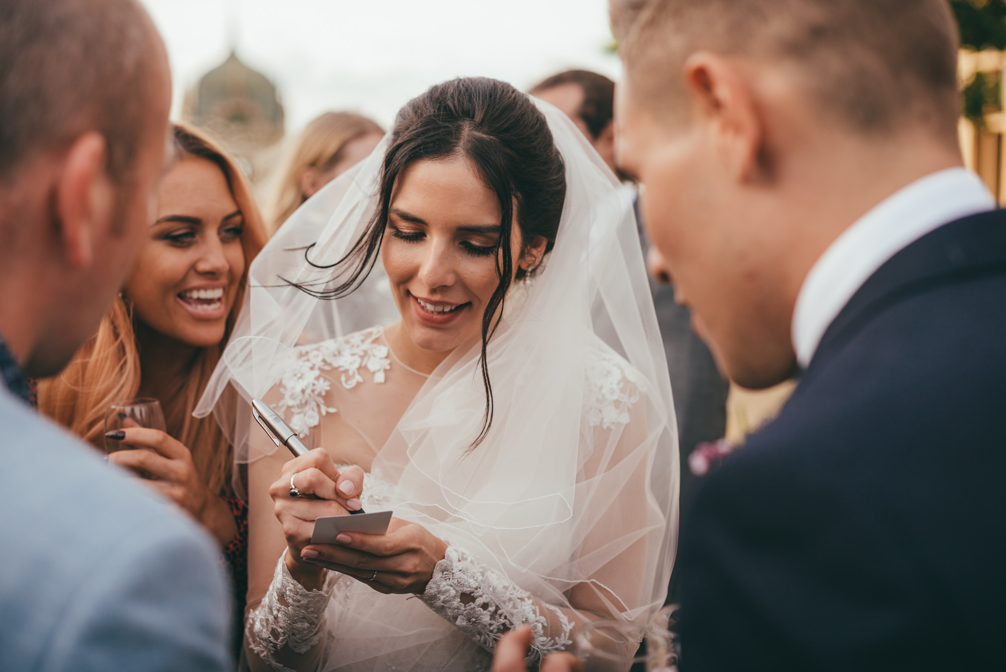 bride writed her name on the back of a playing card