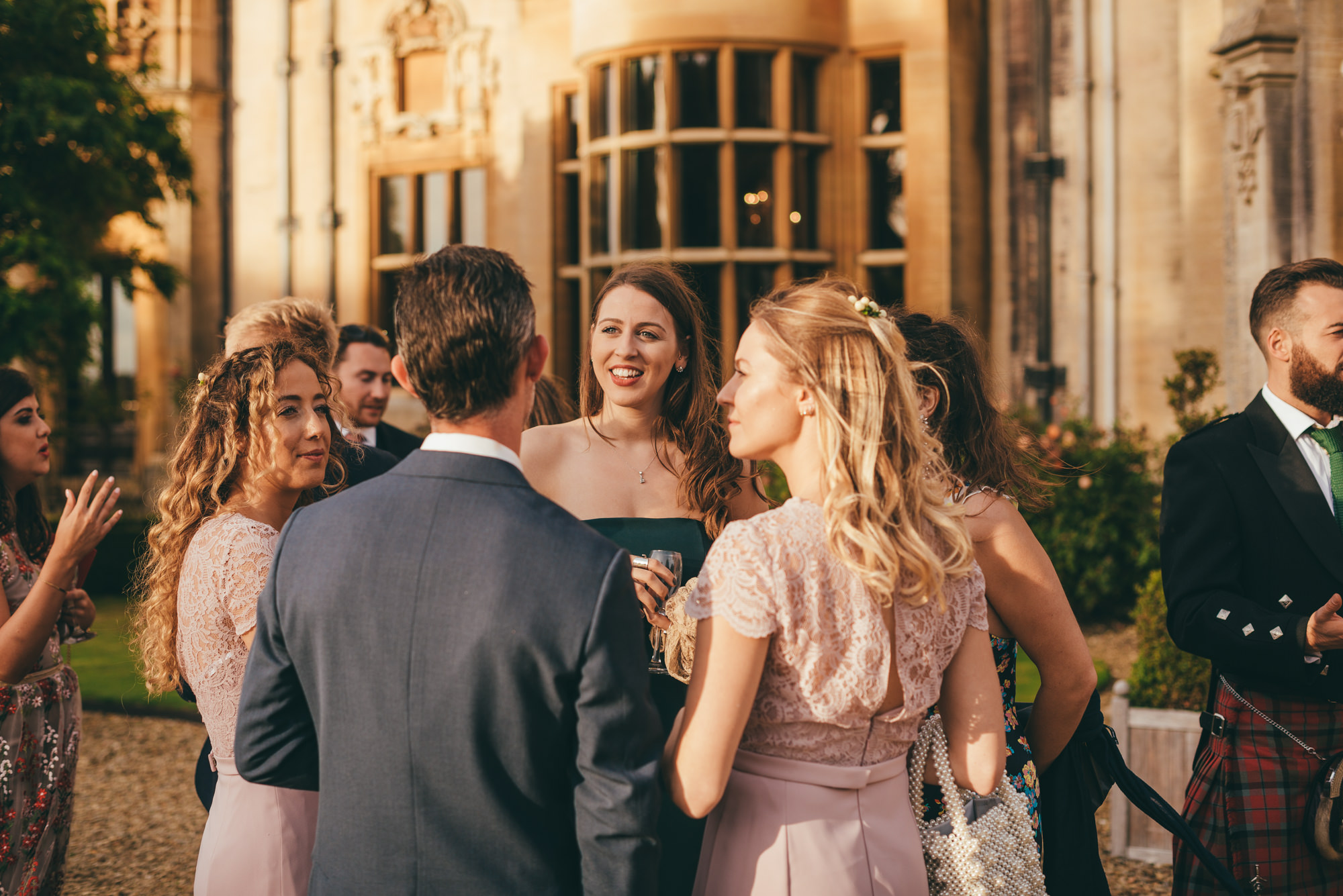 wedding guests talking at harlaxton manor