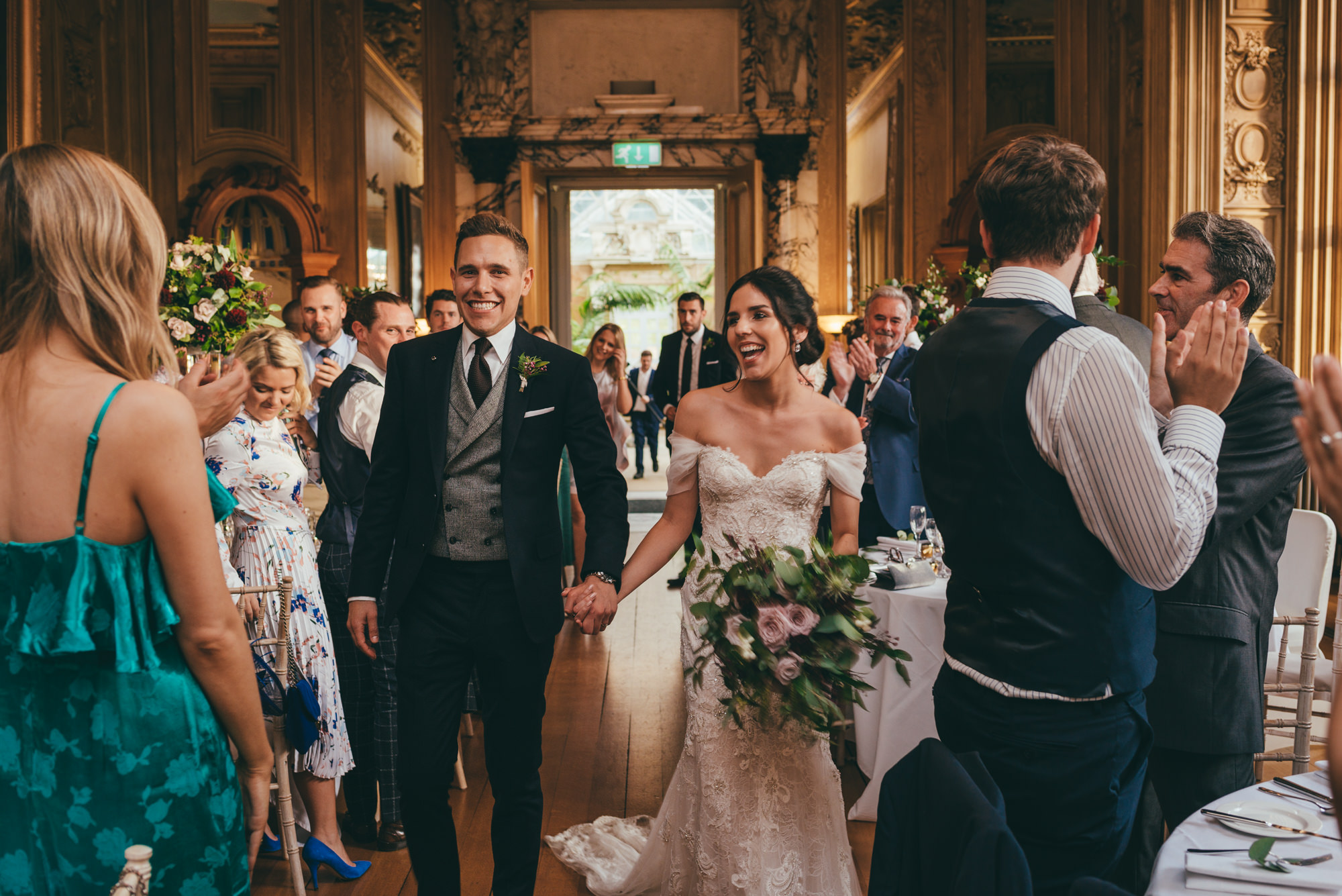 bride and groom are called into the reception room at harlaxton manor