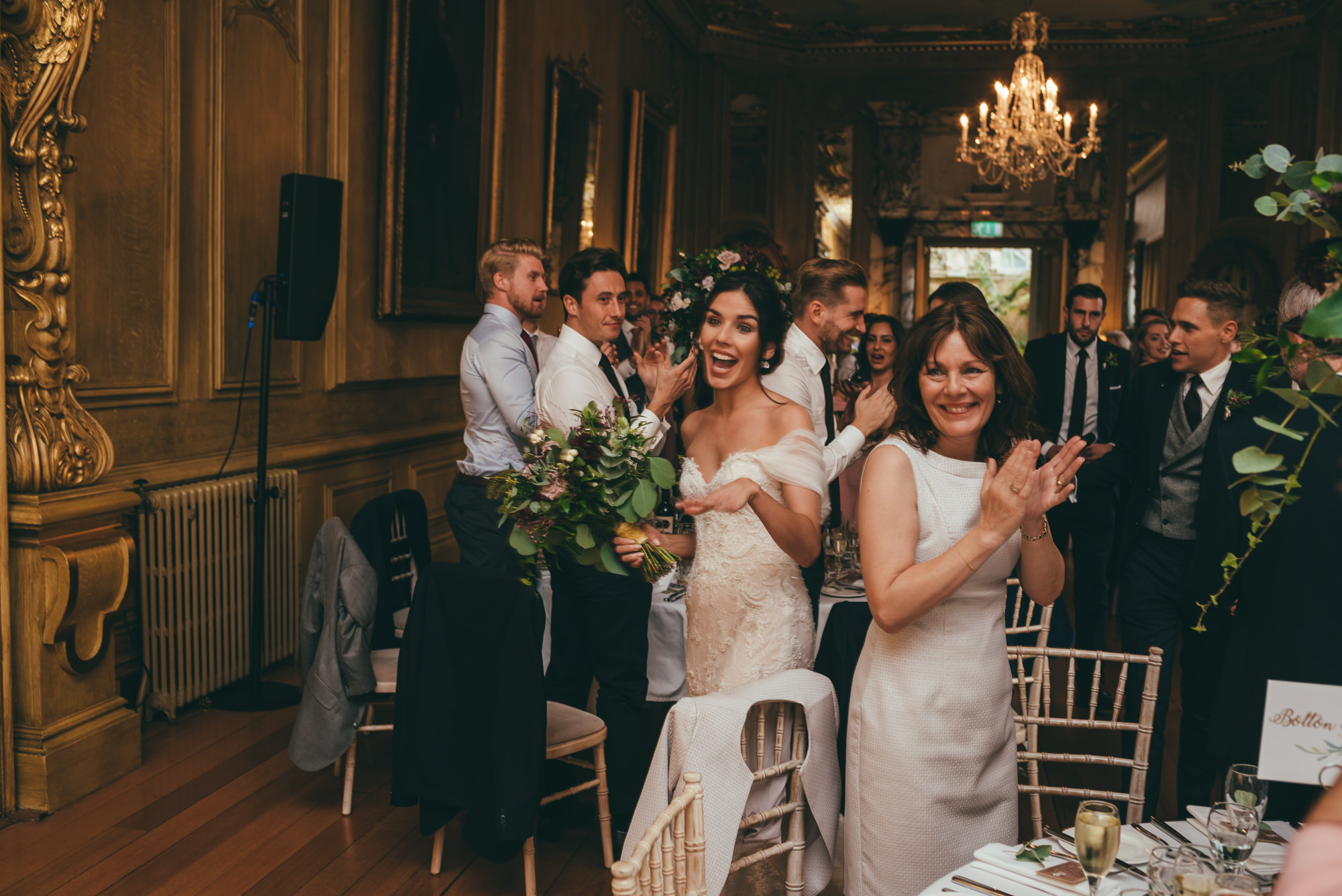 wedding guests cheer in the bride and groom