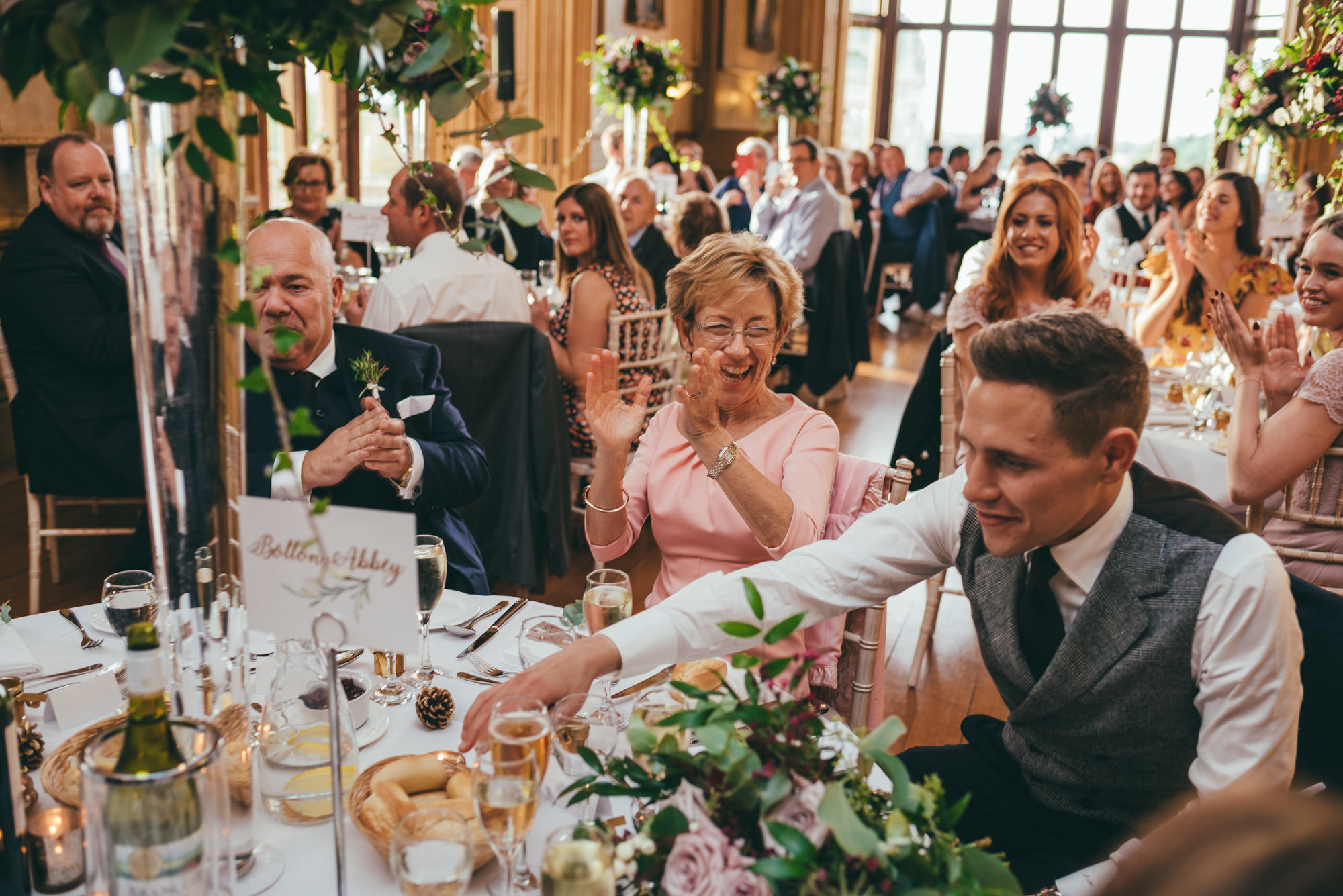 bride and groom being applauded by their wedding guests