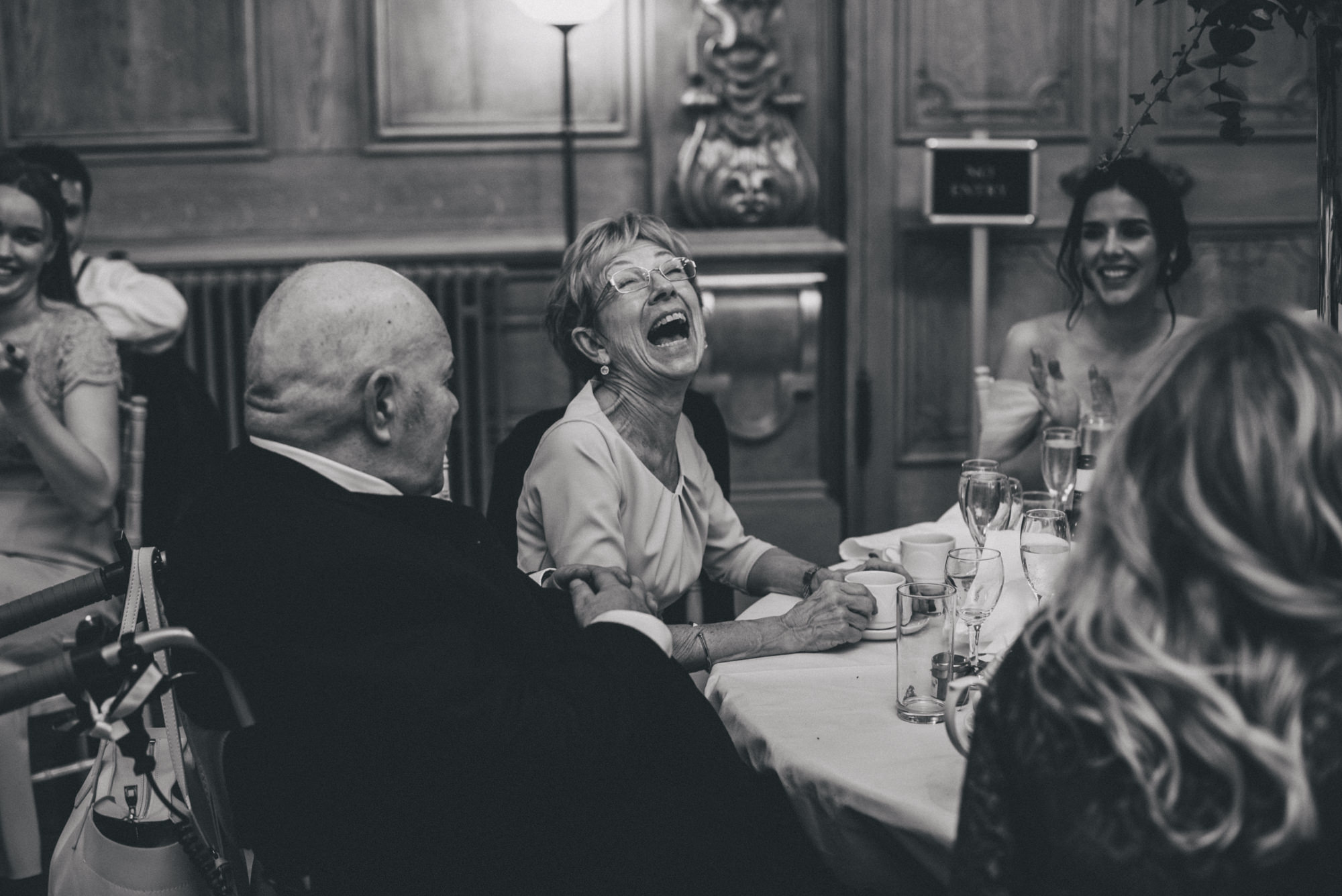 grooms mother laughing at the wedding speeches