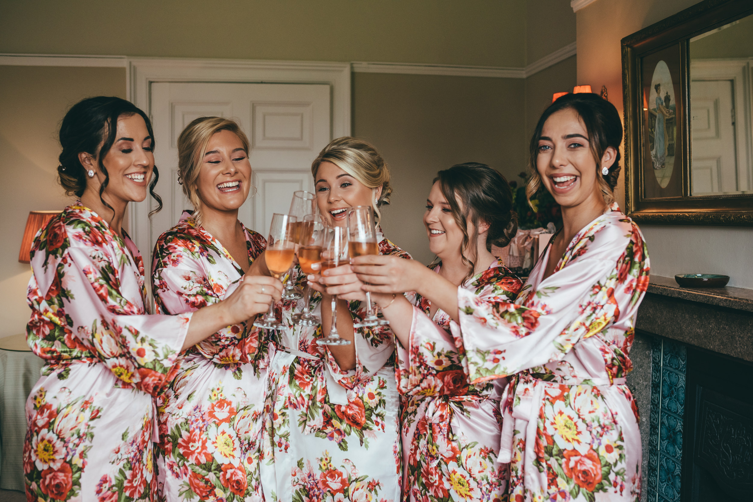 bride and bridesmaids celebrating with champagne during wedding preparations