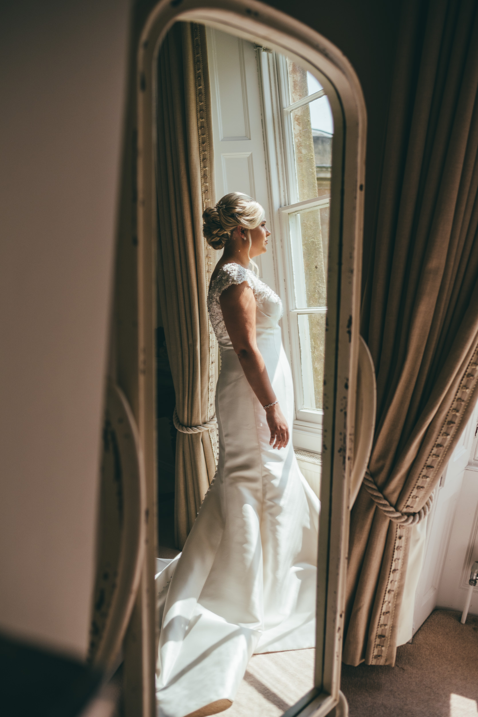 reflection of the bride in a mirror at yeldersley hall