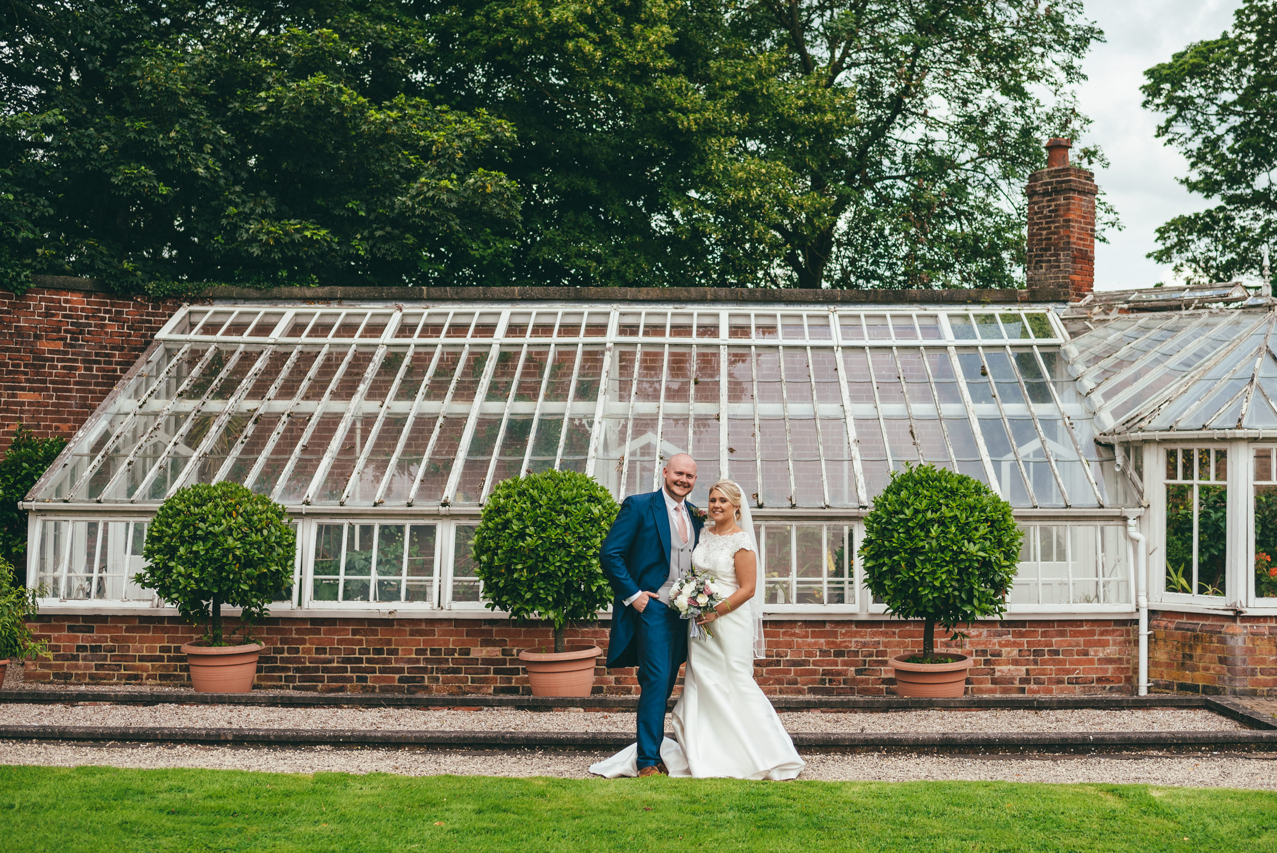 photograph of the bride and grom outside the greenhouse at yeldersley hall