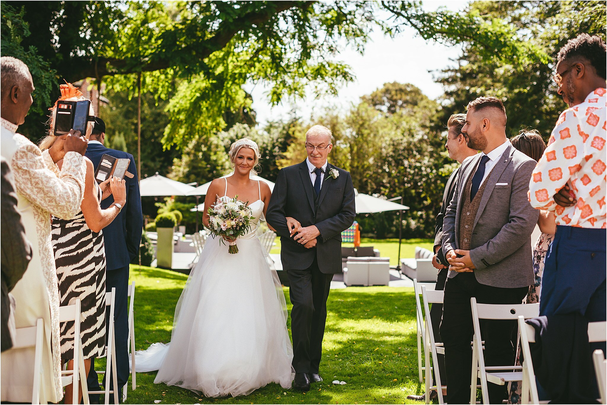 father and the bride walking down the aisle