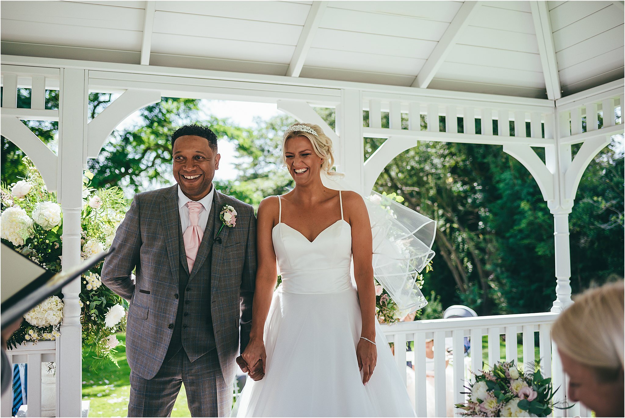 bride and groom sharing a joke during their wedding ceremony