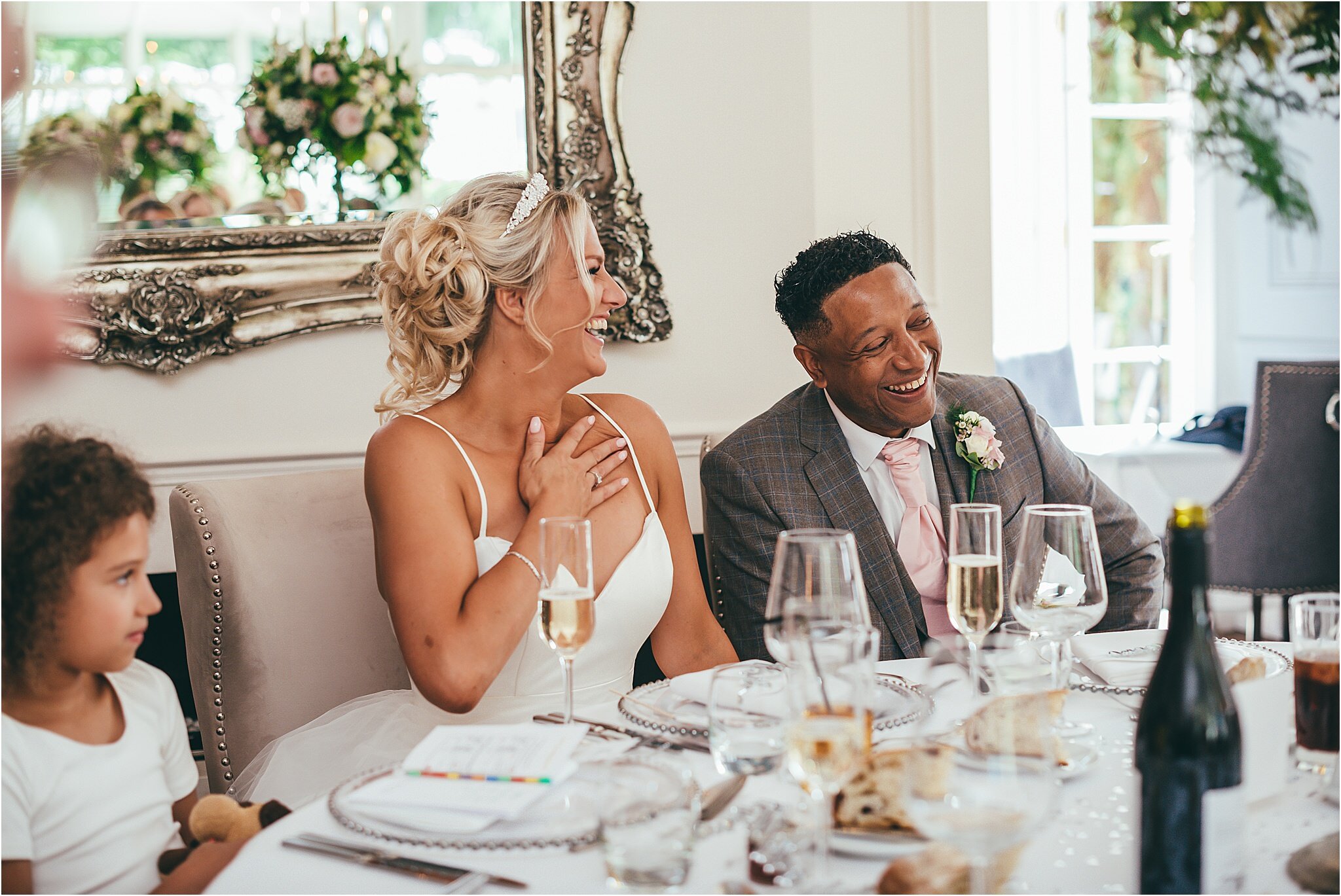 bride and groom laughing during the wedding speeches