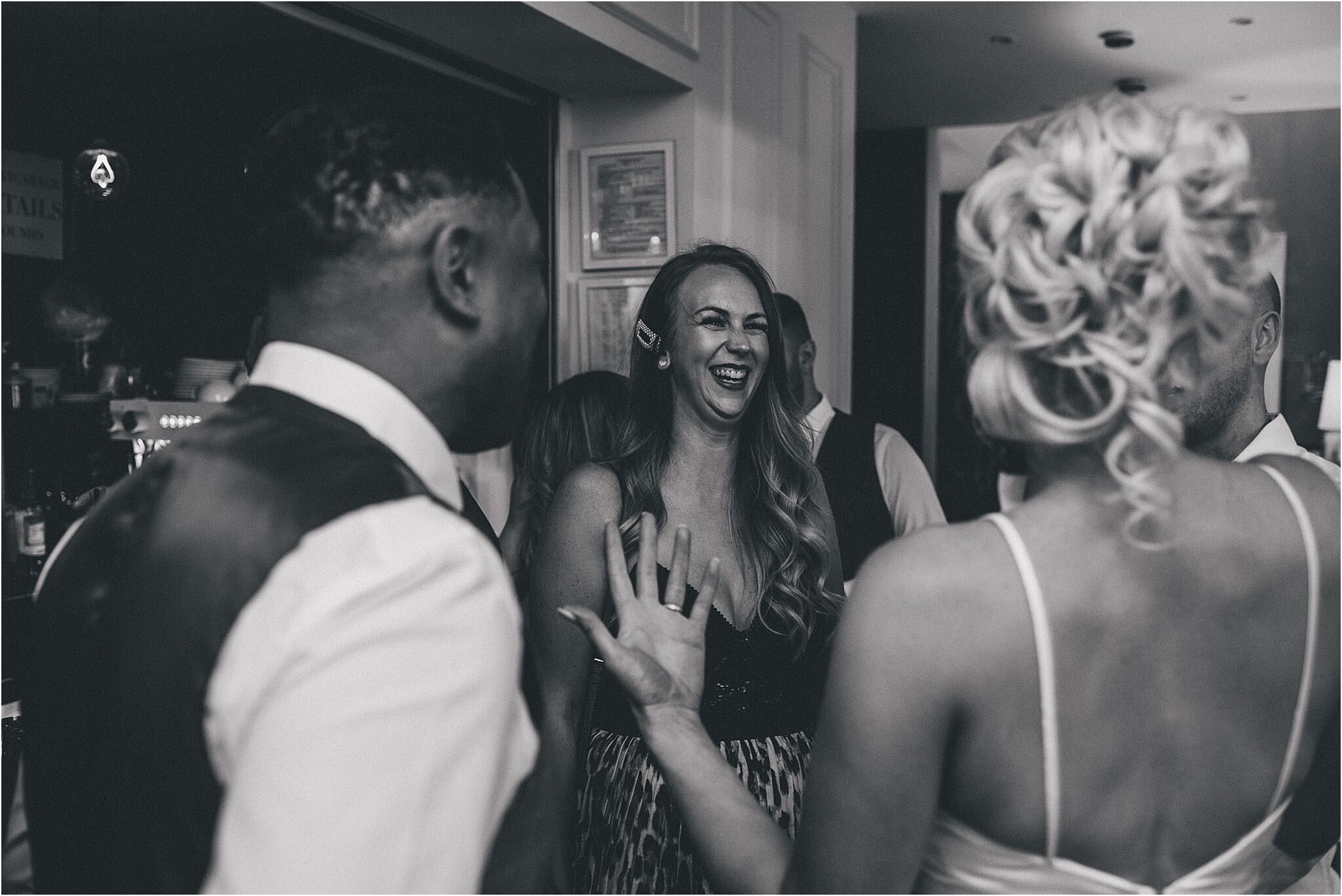 groom and wedding guests sharing a joke