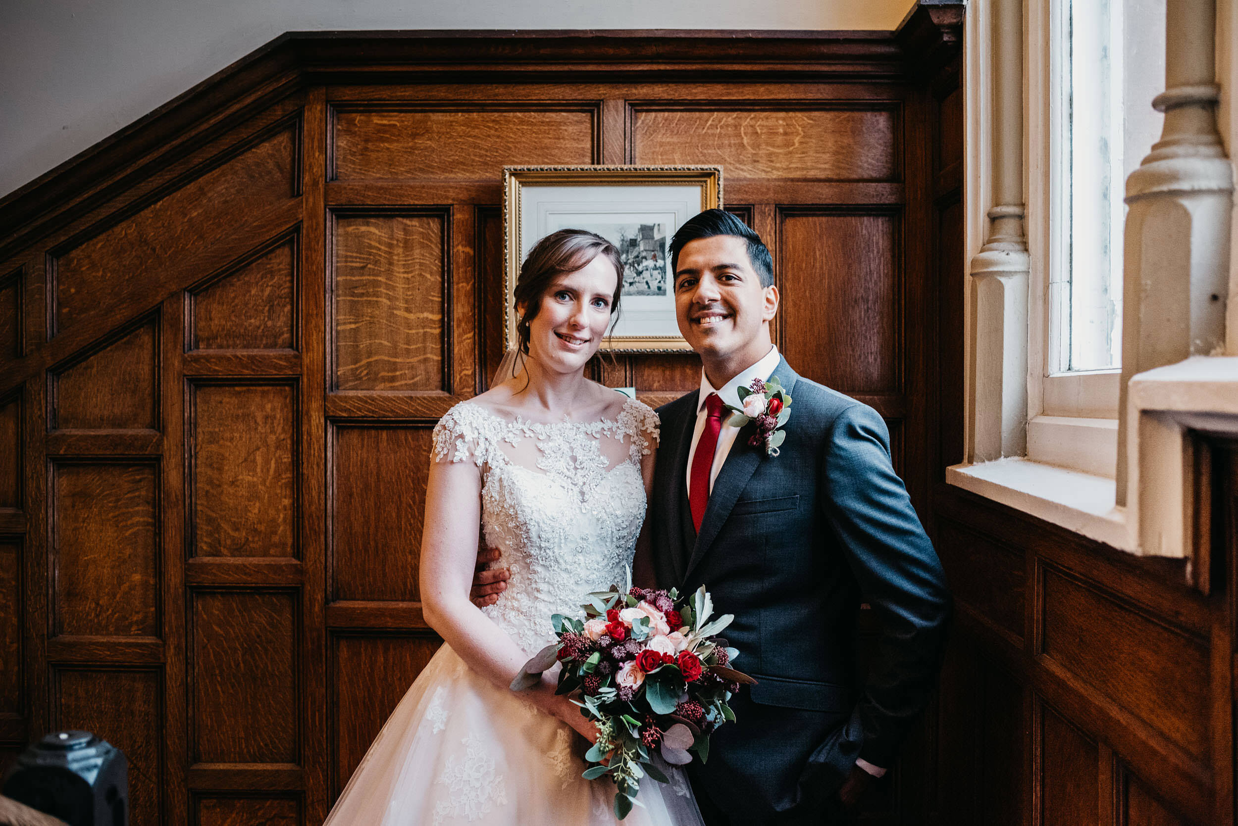 Bride and groom on the stairs at Bestwood lodge 