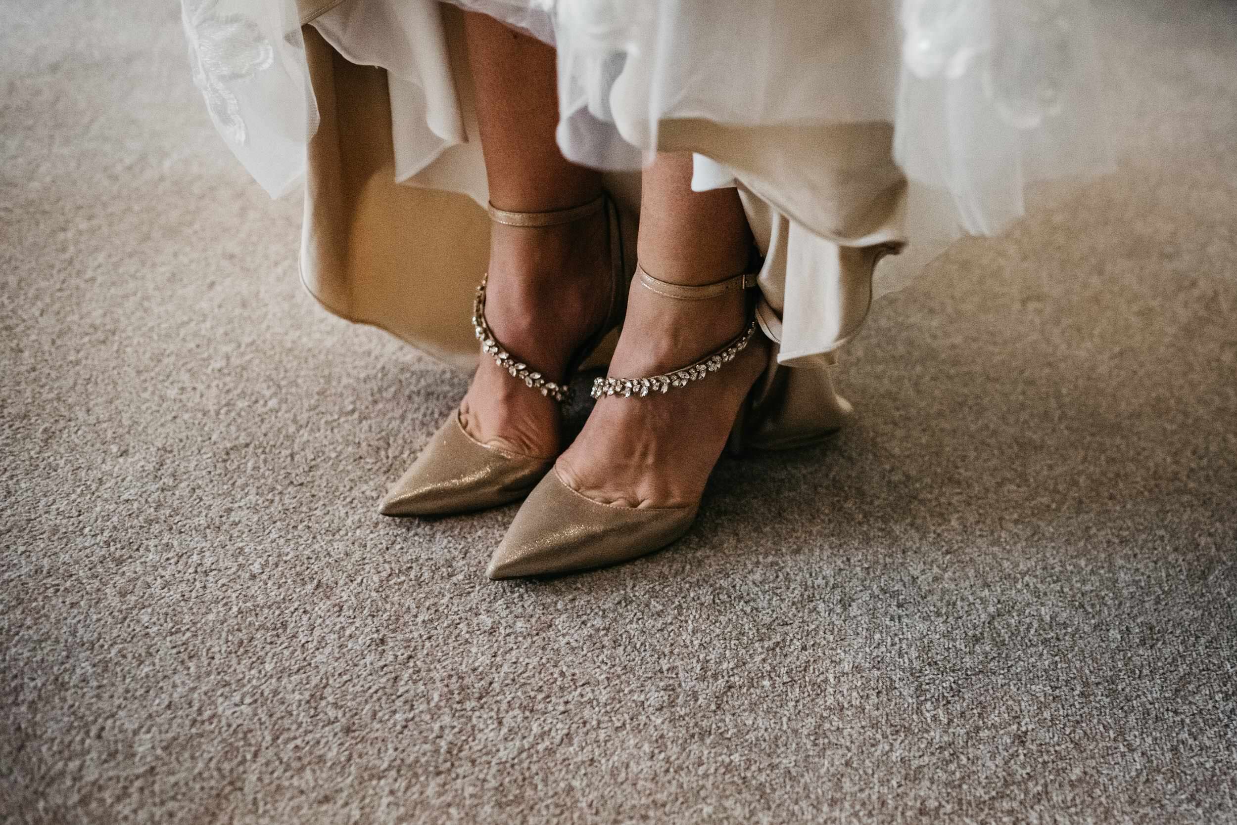 low angle of the brides dress and shoes