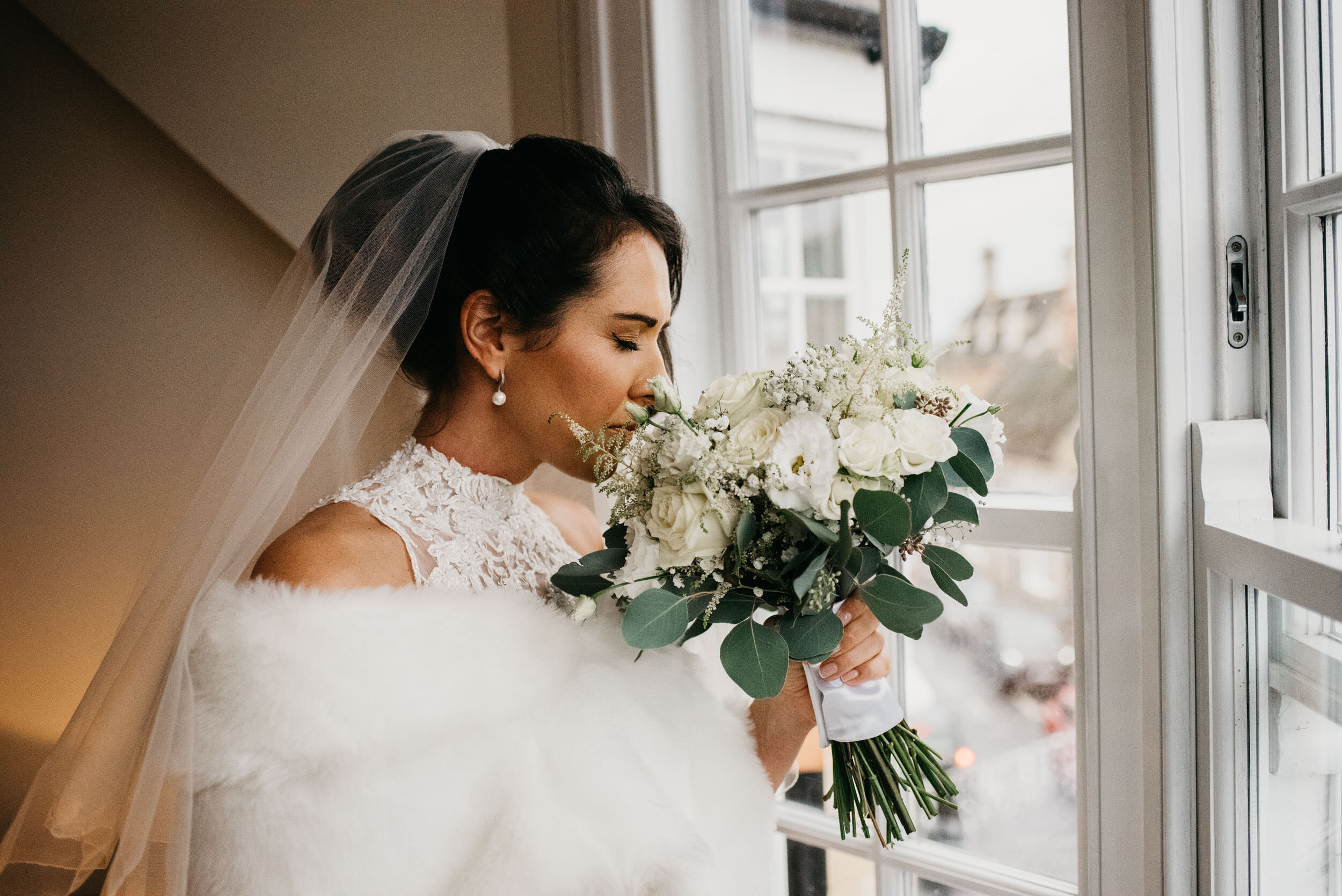 bride smelling her wedding flowers