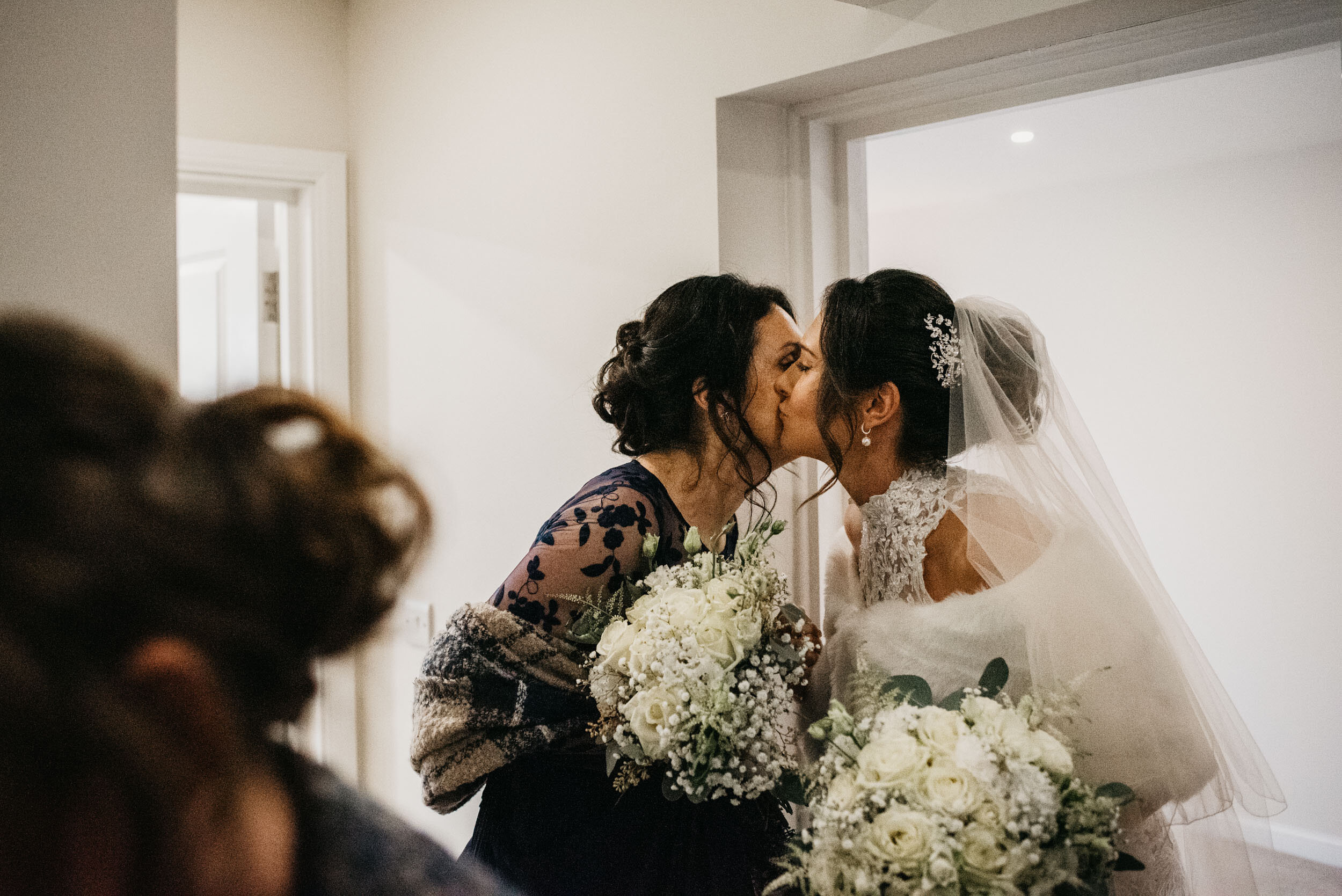 bride kissing her maid of honour