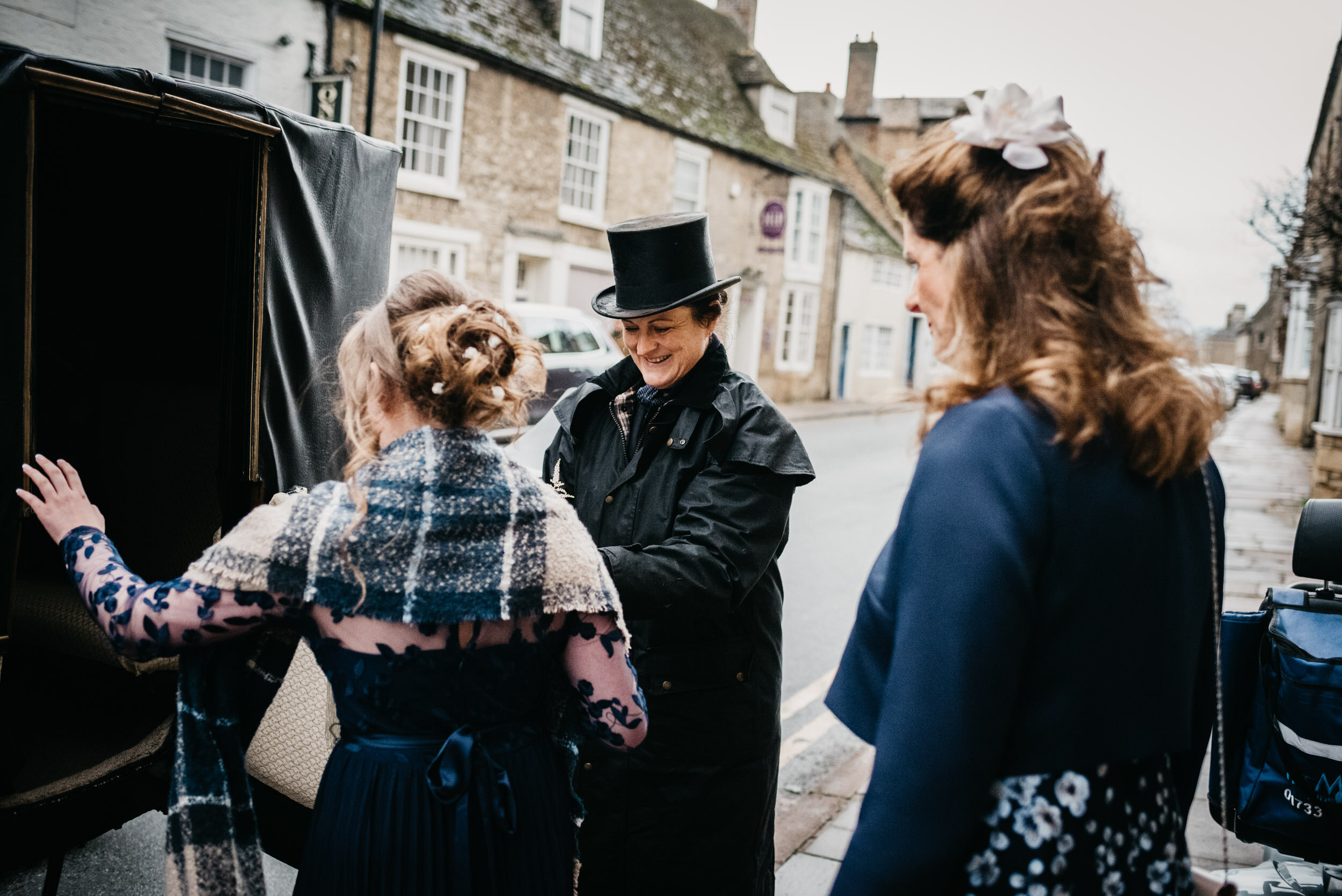 bridesmaids getting into the horse carriage in oundle