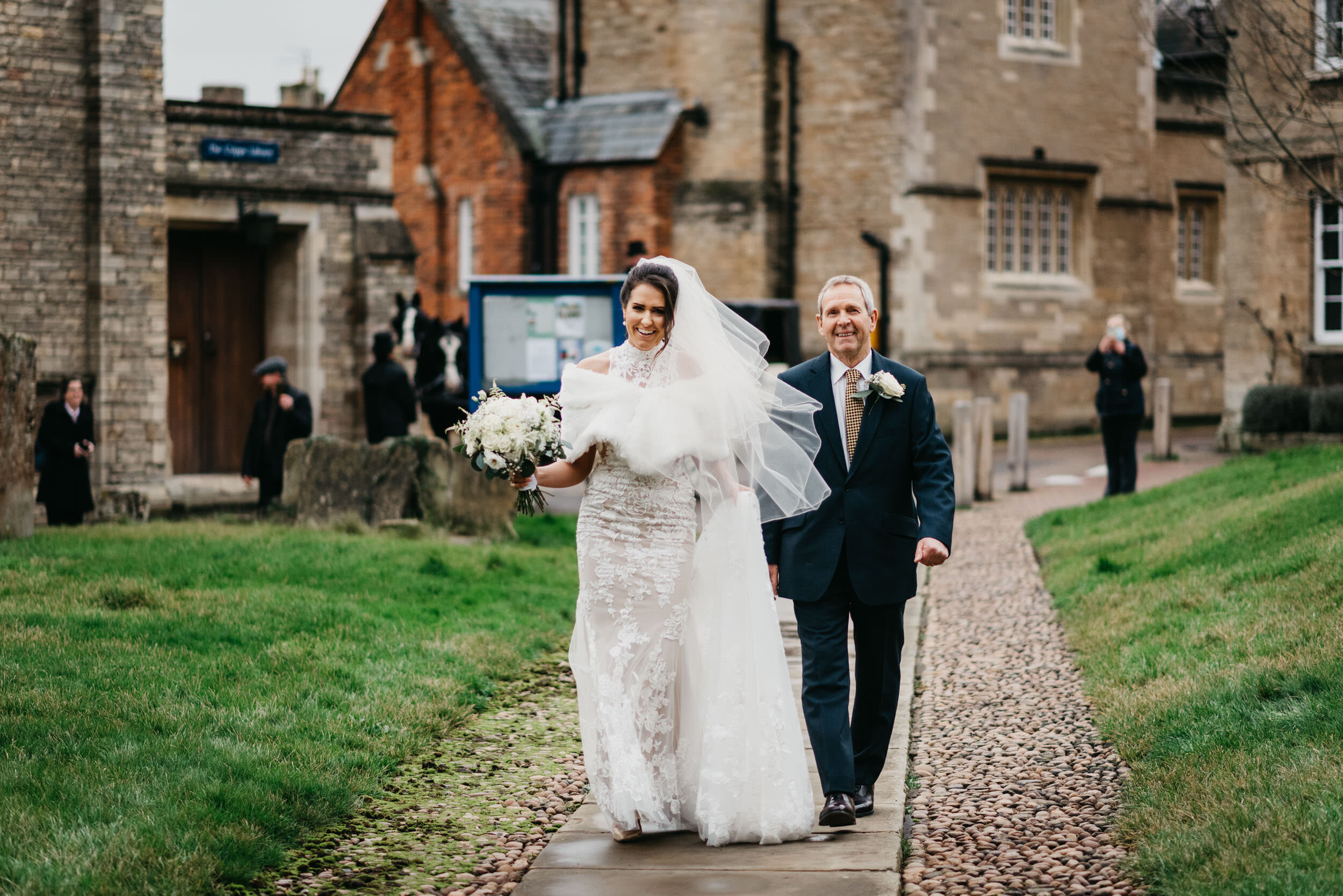 bride and her father walking to St Peters Church in Oundle