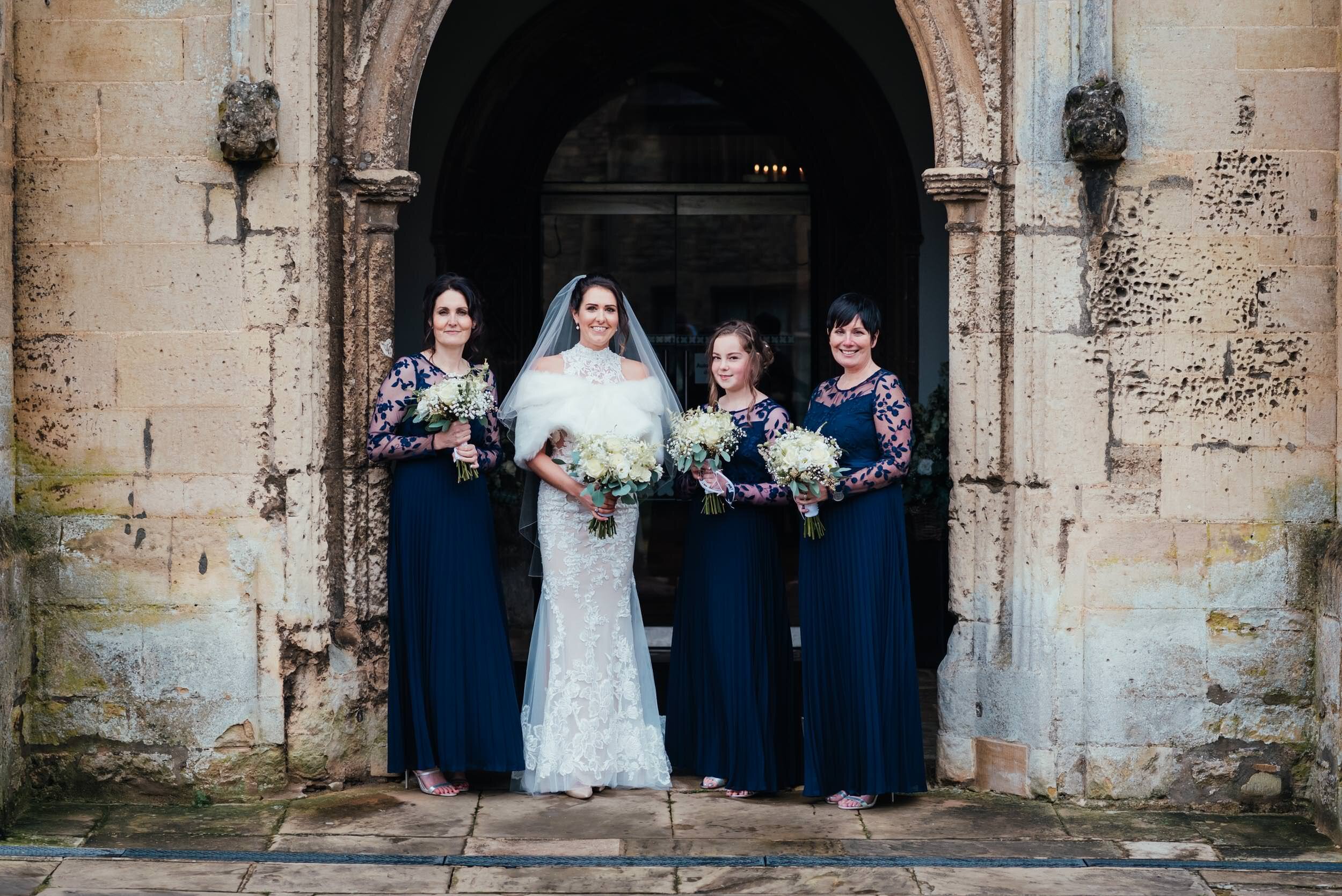 group photograph of the bridal party at St Peters Church in Oundle. Oundle Wedding Photographer