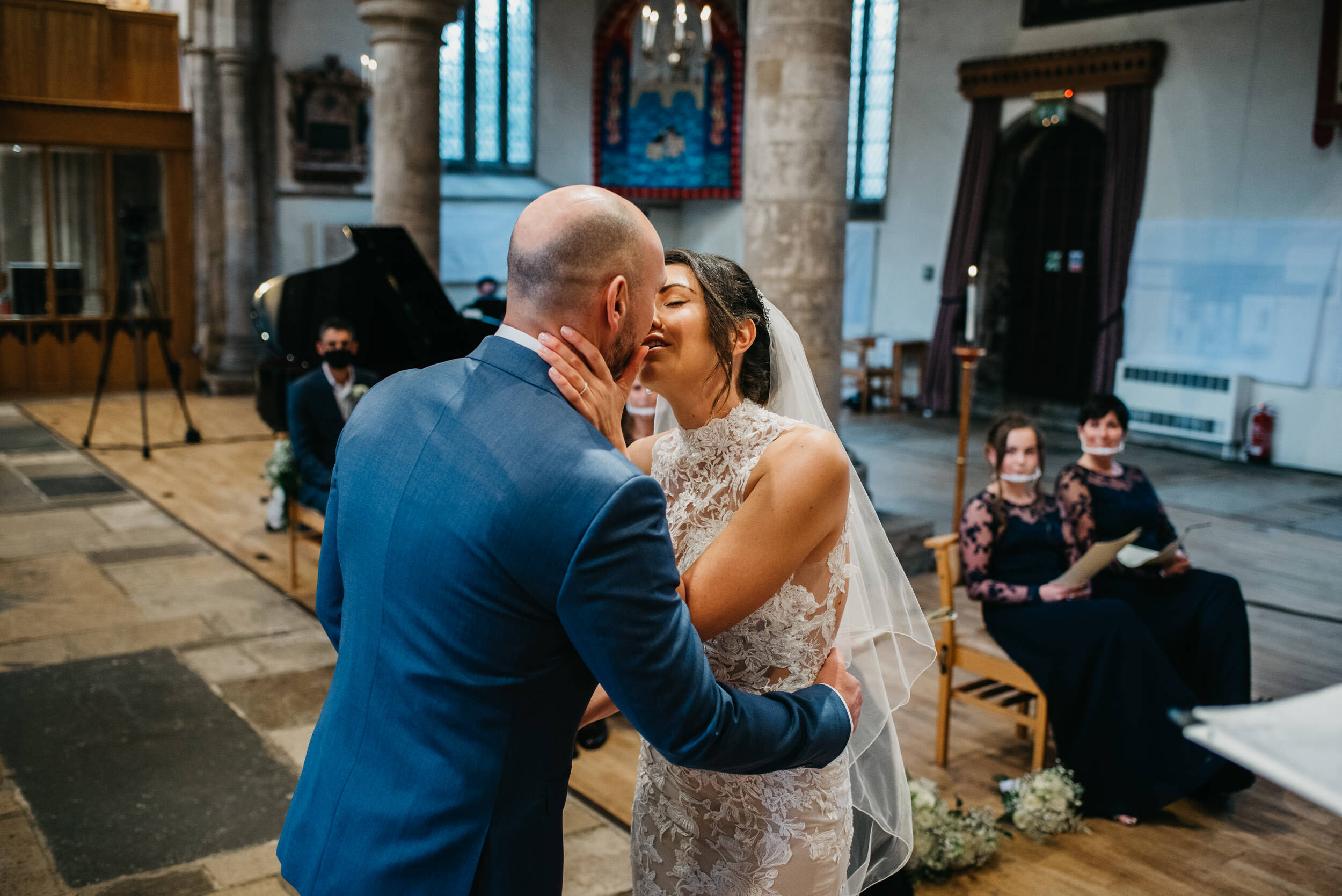 Bride and groom first kiss at S Peters Church in Oundle