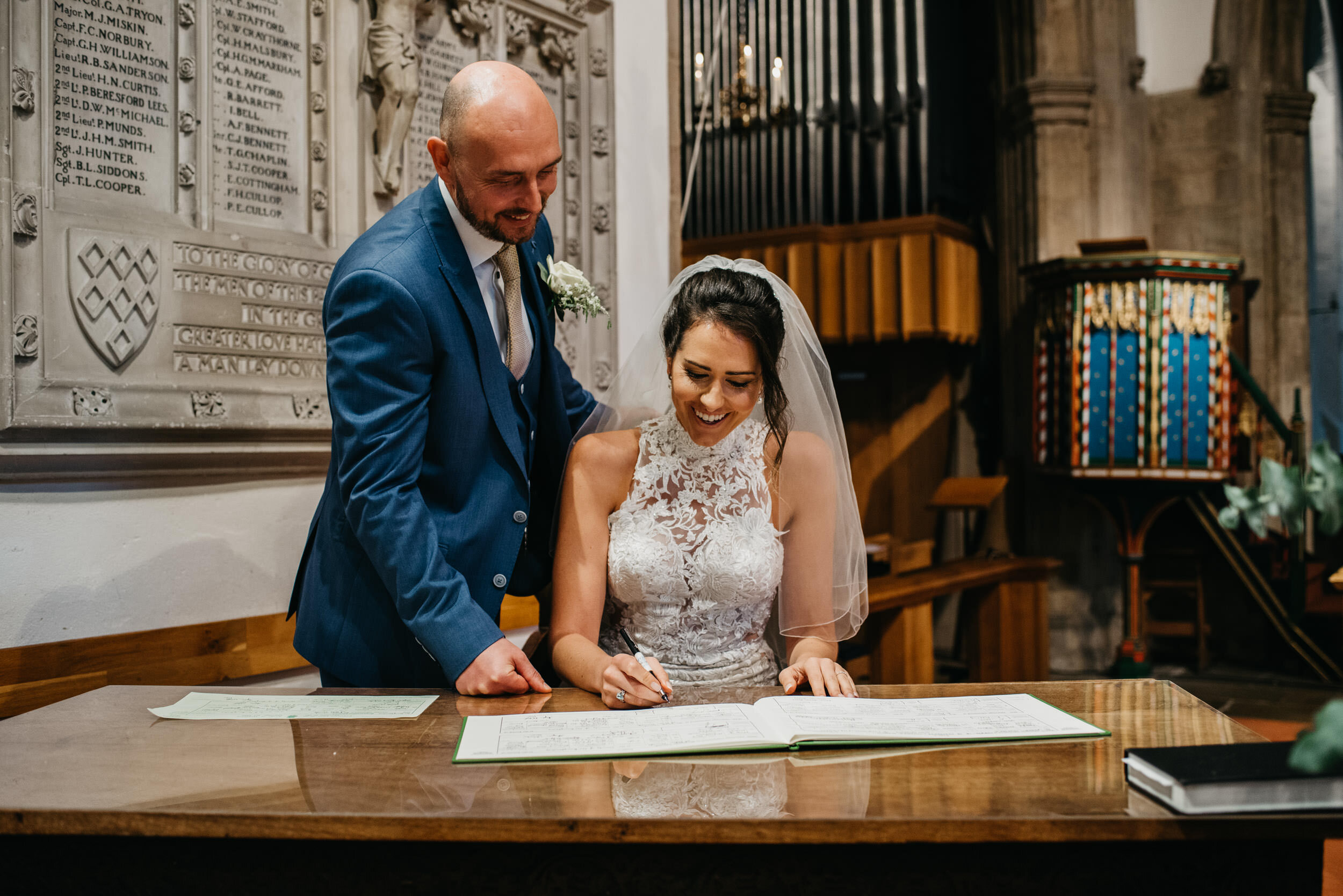 bride and groom signing the wedding register