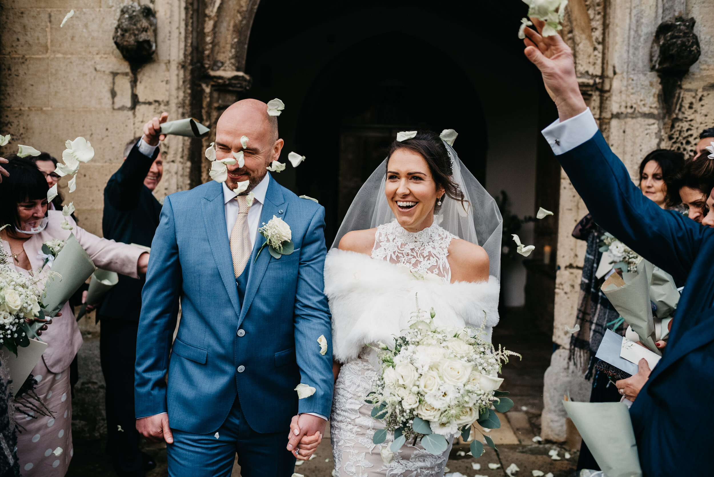 guests throwing confetti over the brider and groom at St Peters Church in Oundle