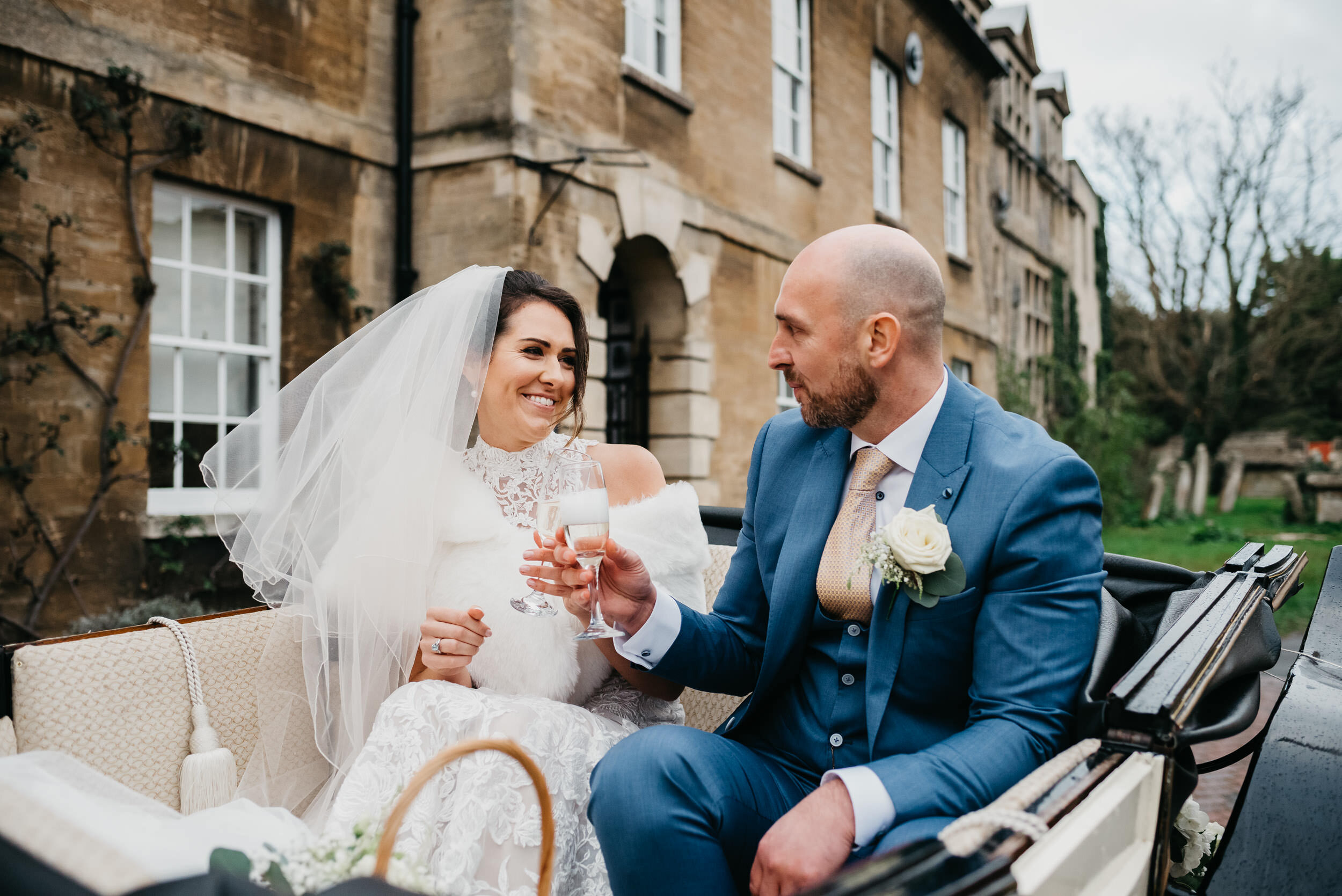 drinking champagne in a horse and carriage in Oundle. Oundle wedding photographer
