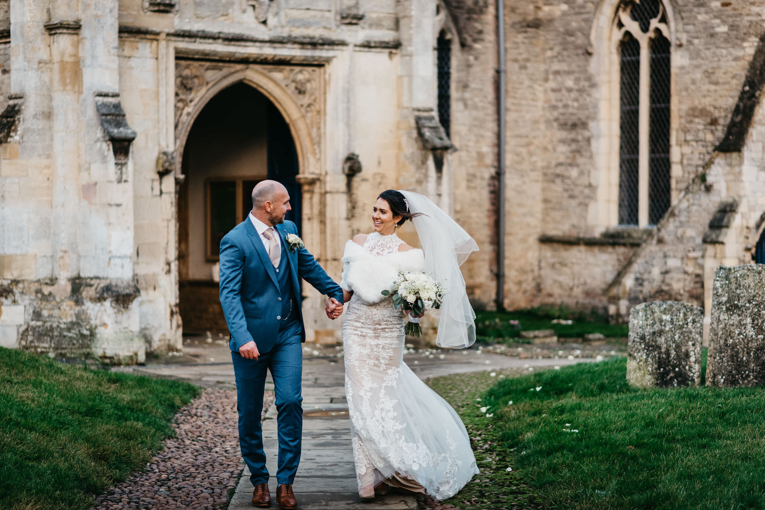 bride and groom walking portrait in Oundle. 