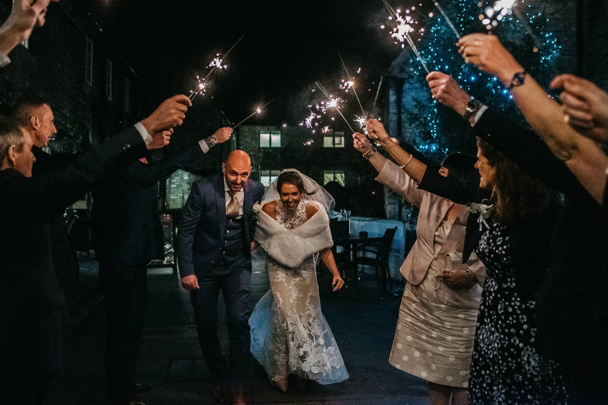 Bride and groom with sparklers at the Talbot Hotel in Oundle
