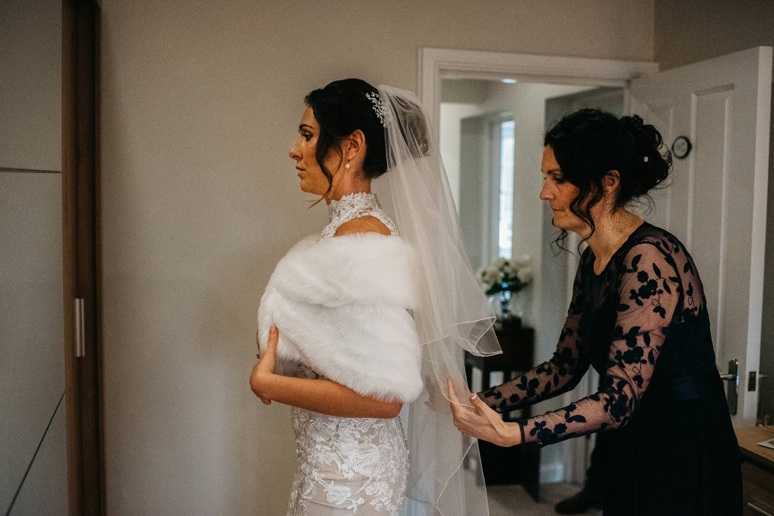 maid of honour correcting the brides veil