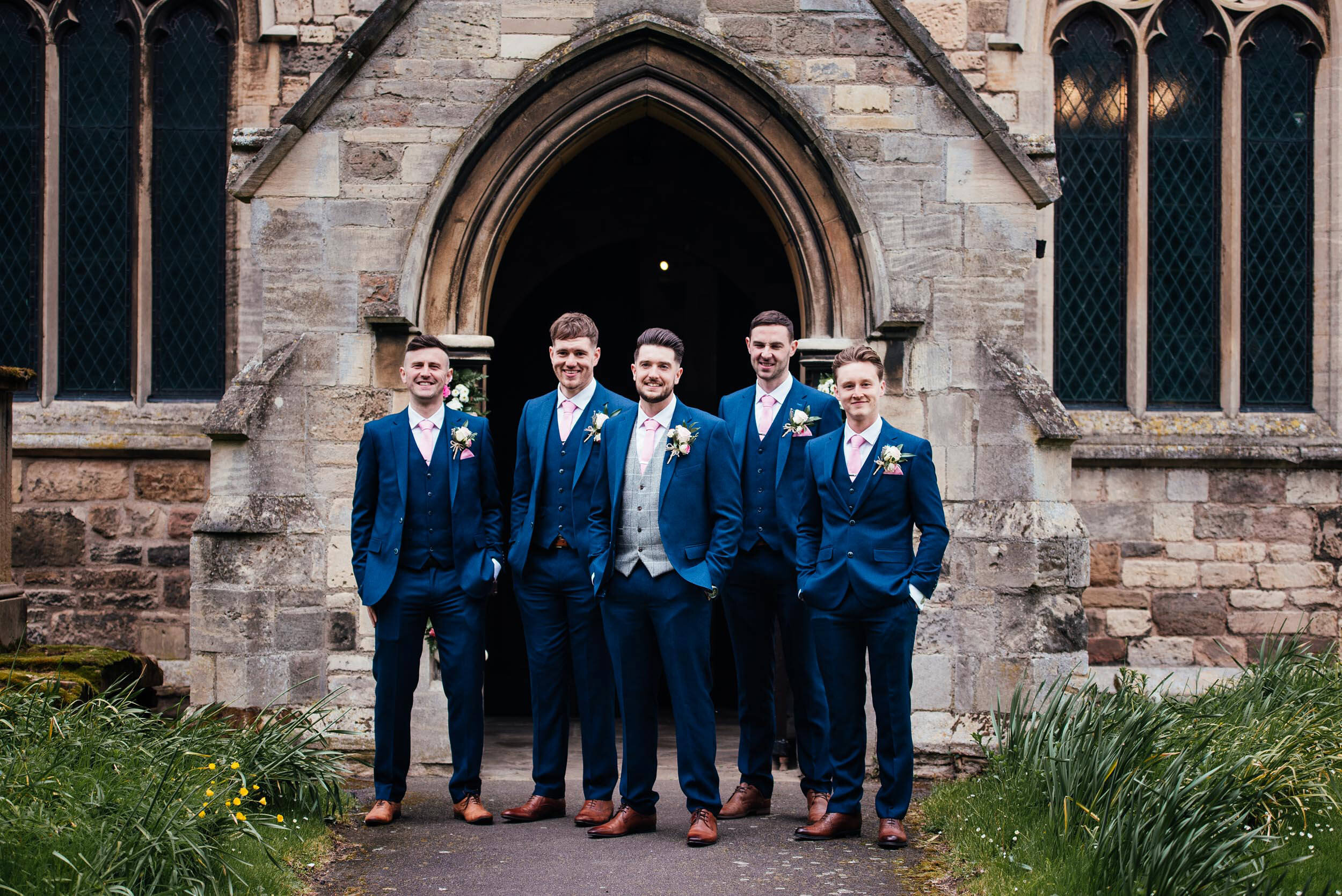 photo of the groomsman outside the front of the church