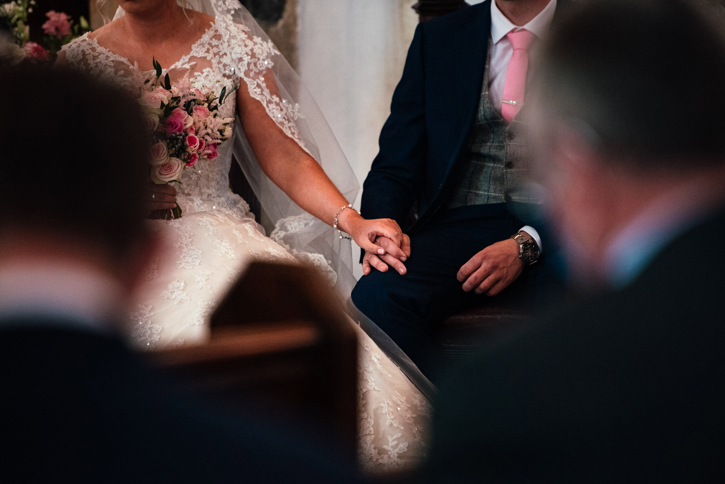 bride and groom holding hands during the wedding ceremony 