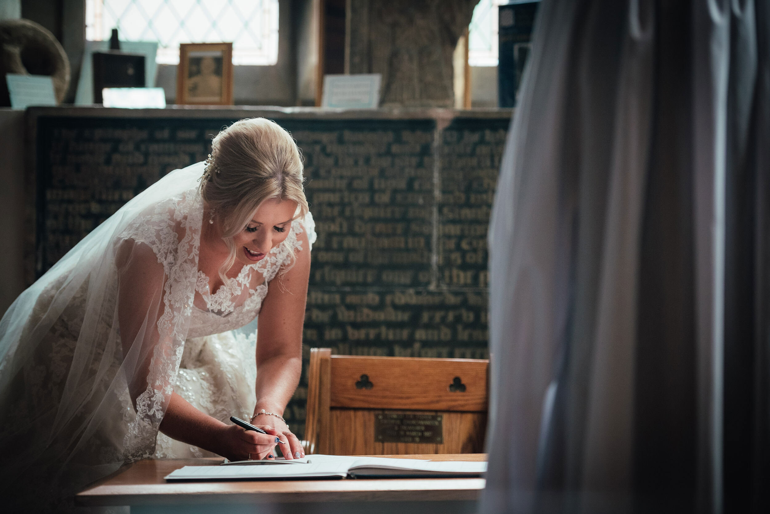 bride signing the wedding register 