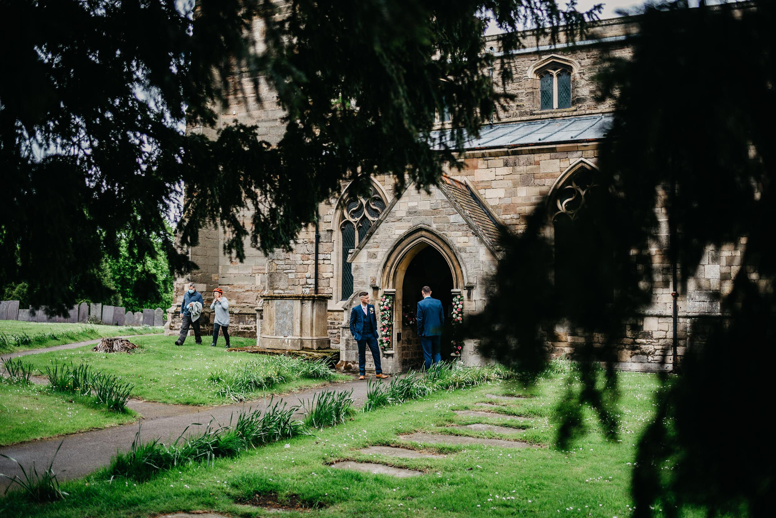 view of church through the  trees