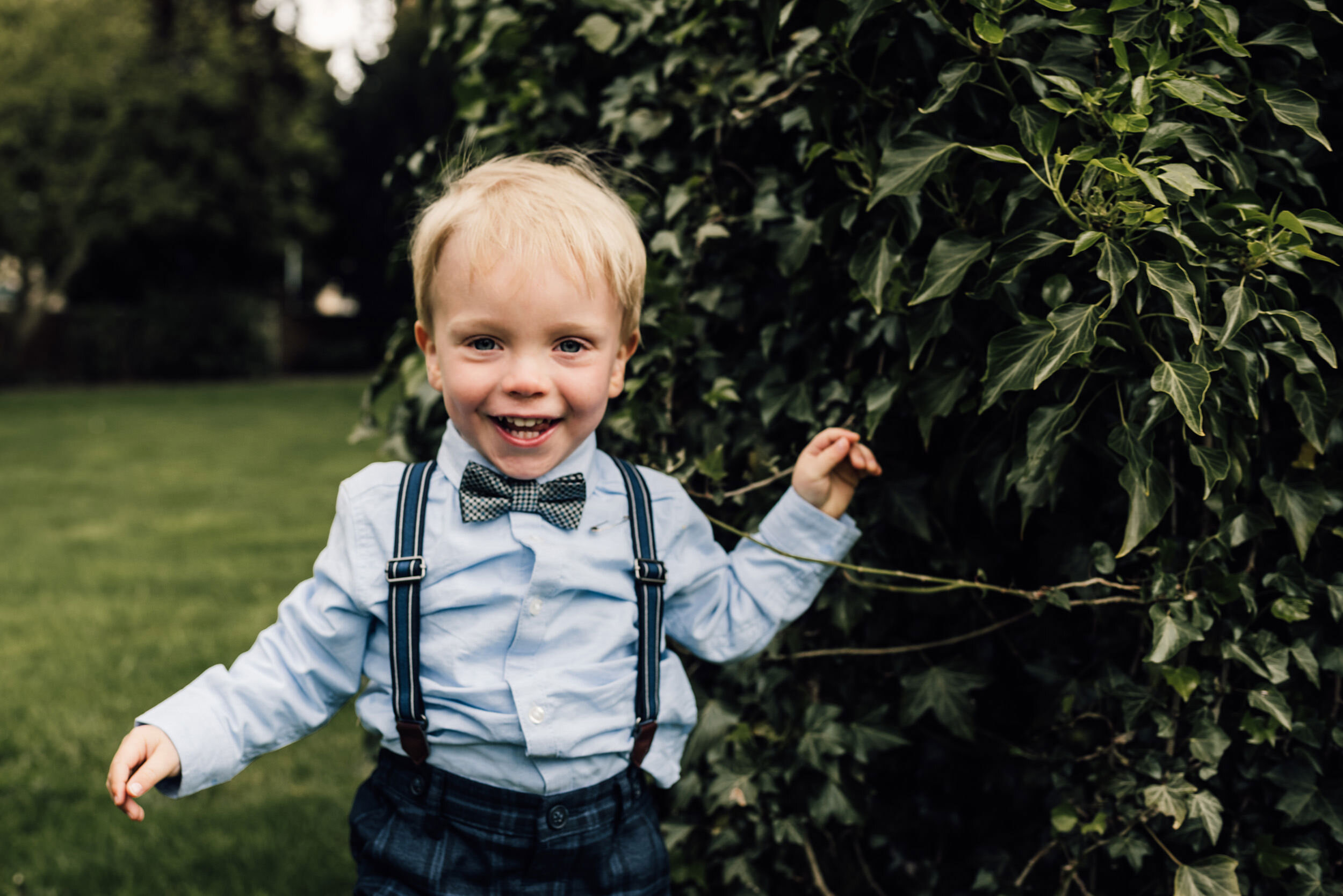 Young boy laughing at the wedding