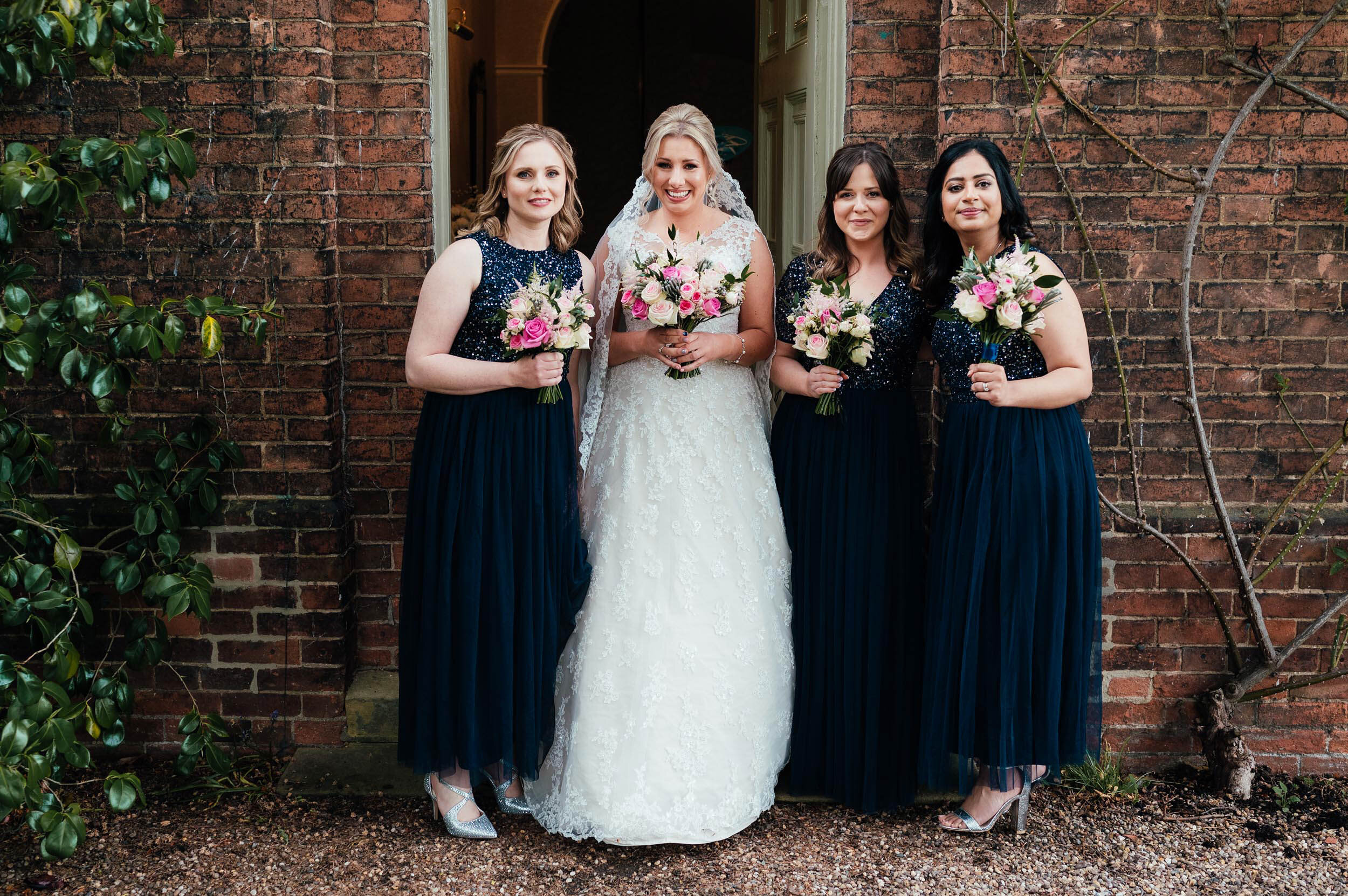 the bride and  her bridesmaids outside the house
