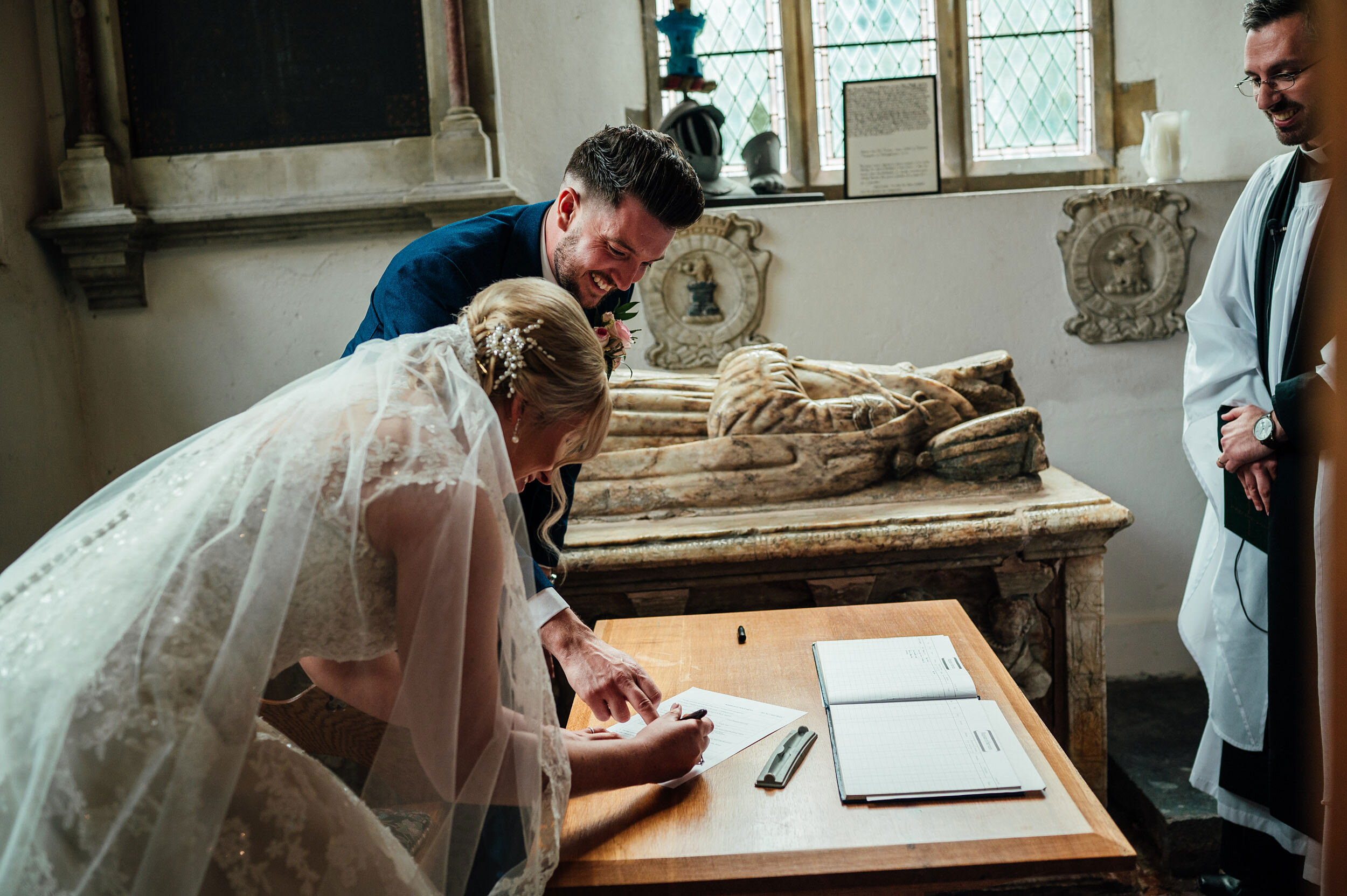 bride and groom signing the wedding register