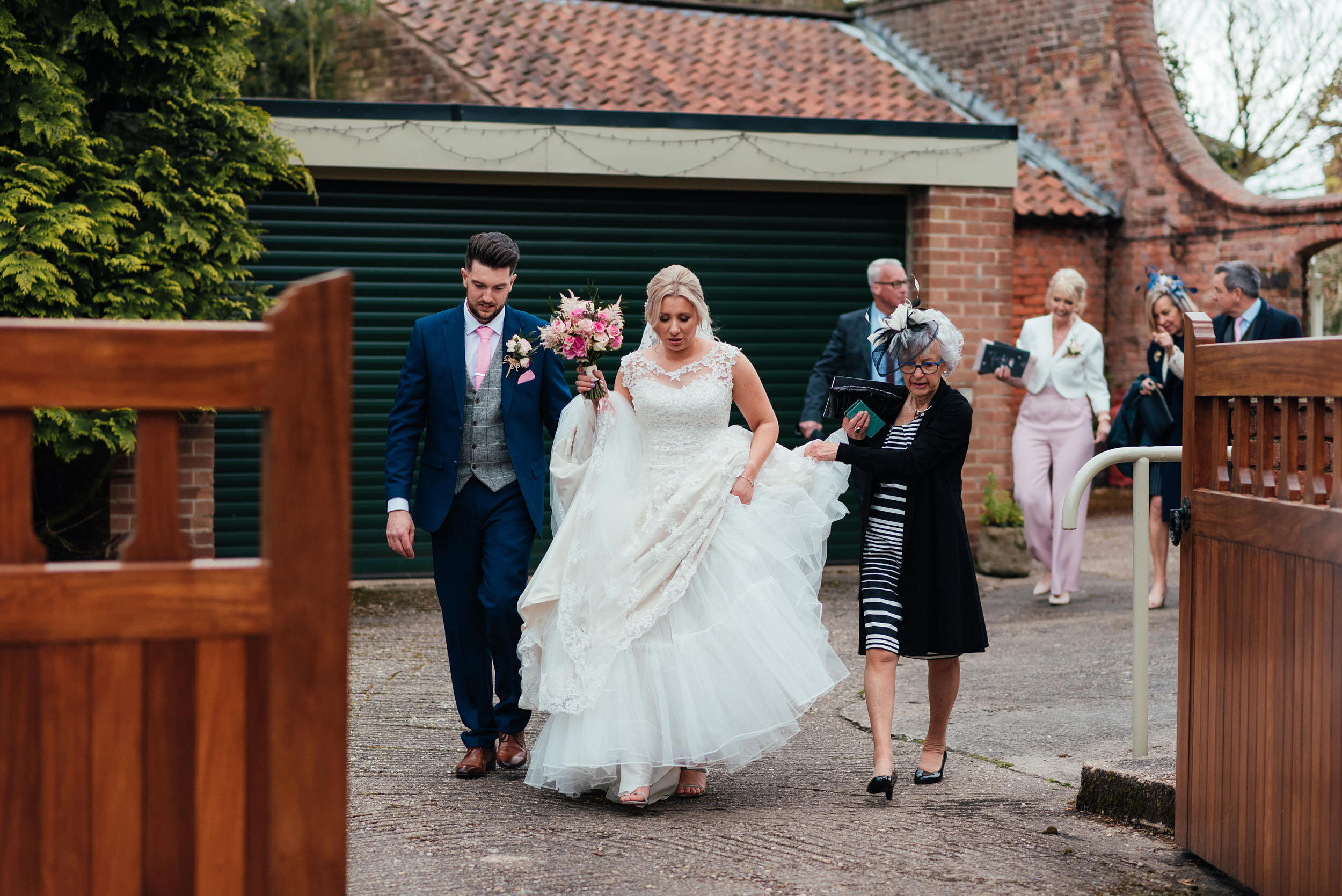 bride  and groom walking to the wedding reception in Shelford, Nottingham