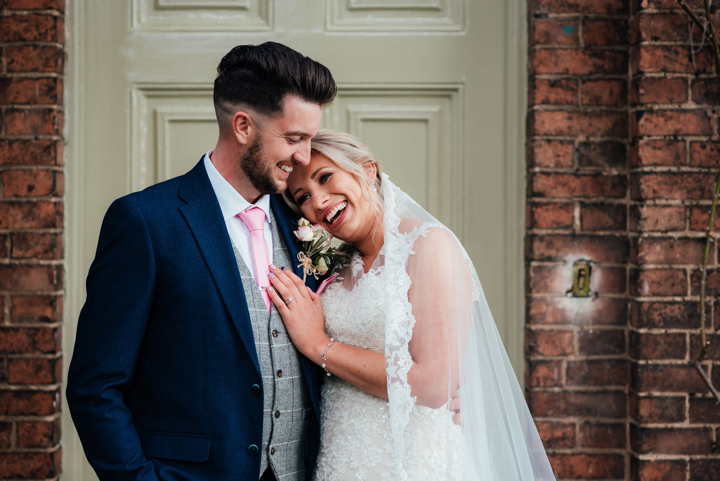 bride places her head on the grooms shoulder