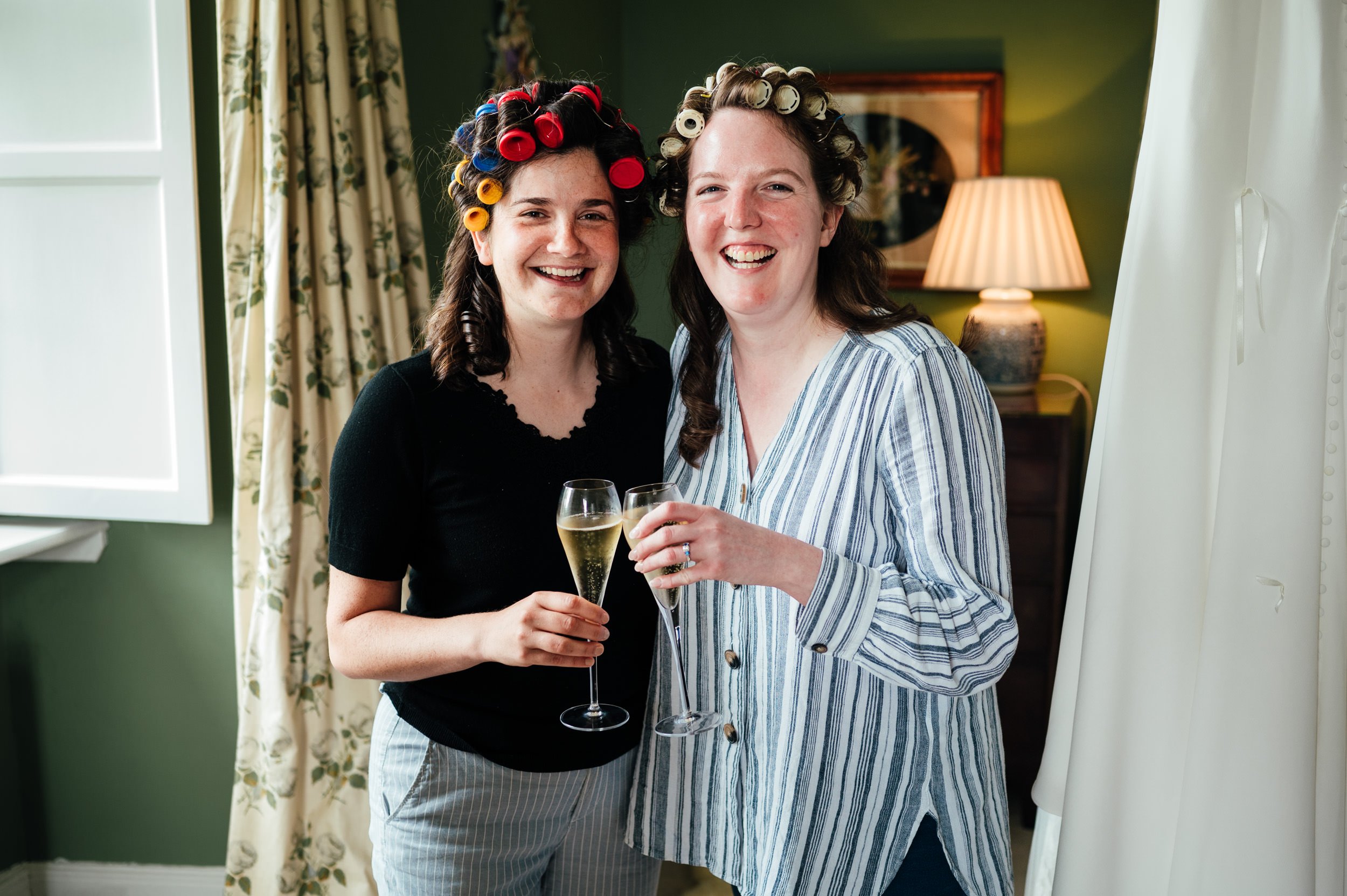 bride and bridesmaid pose for a picture