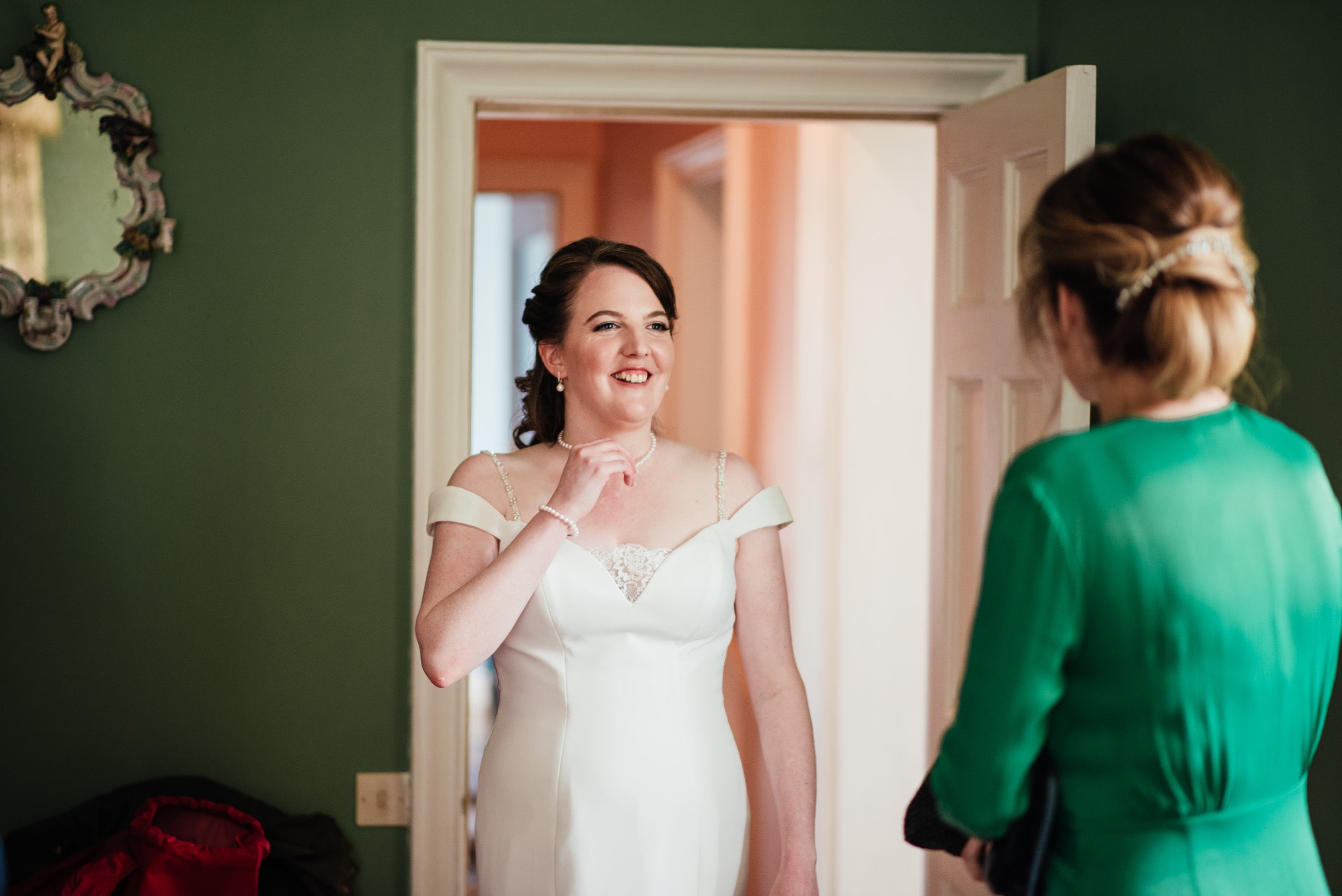 bride laughing with a bridesmaid