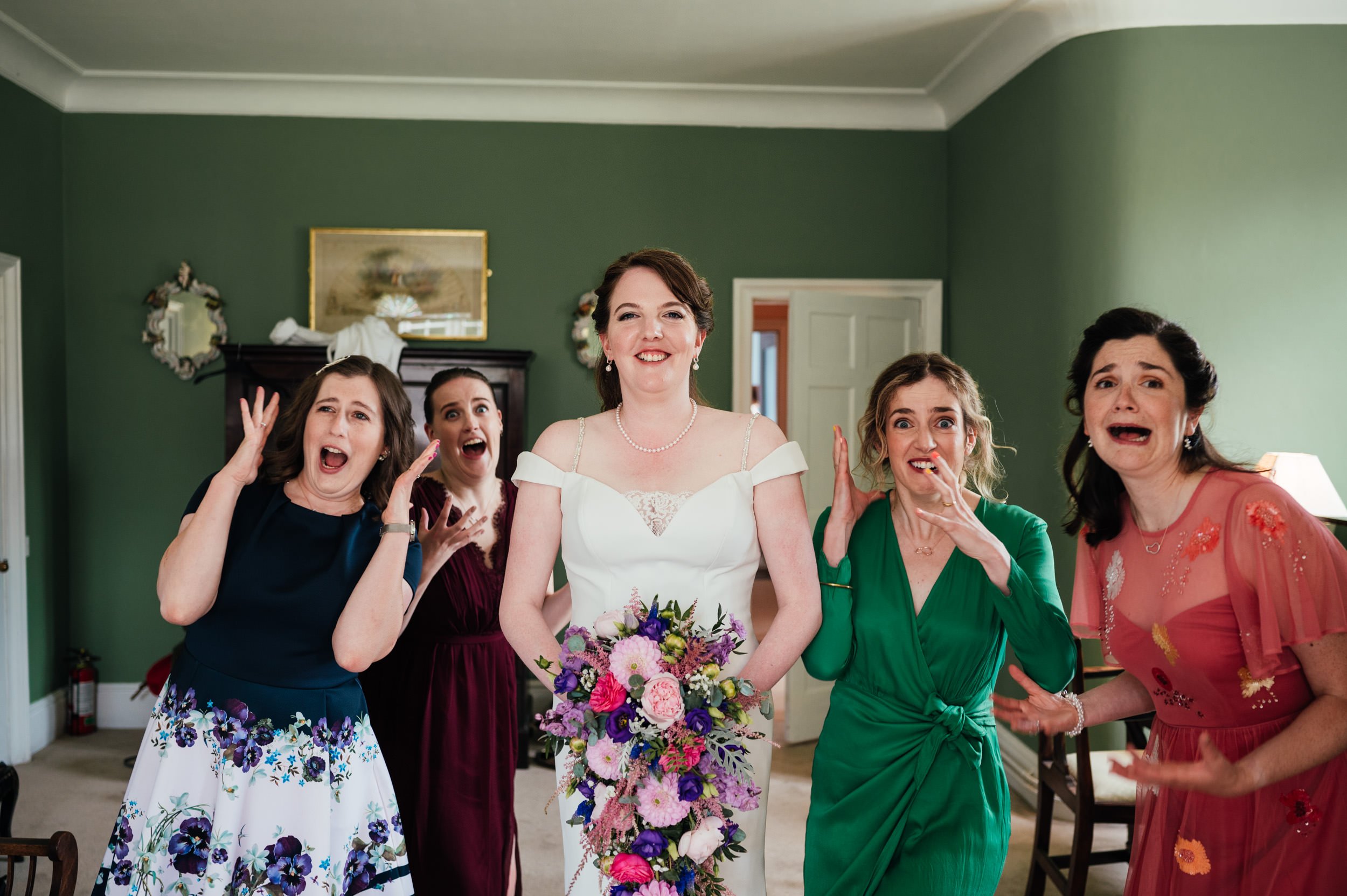  a picture of the bride and bridesmaids laughing