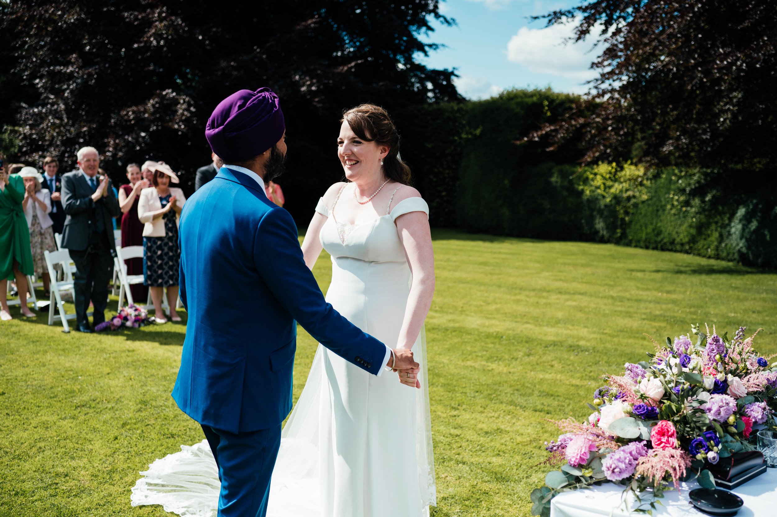 bride and groom smiling at each other during the ceremony